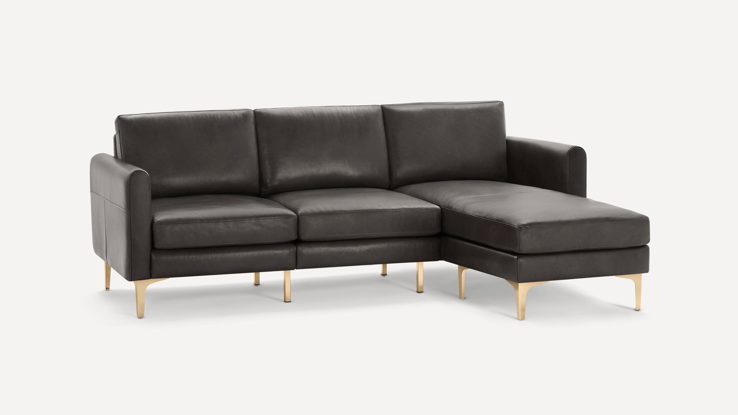 Dark gray leather sectional sofa with chaise, featuring sleek gold metal legs and modern clean lines.