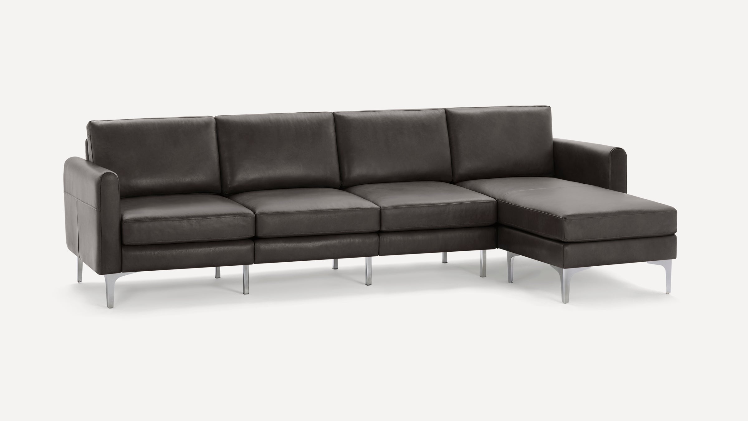 Modern dark gray leather sectional sofa with sleek metal legs and right-side chaise lounge, designed for contemporary living spaces.