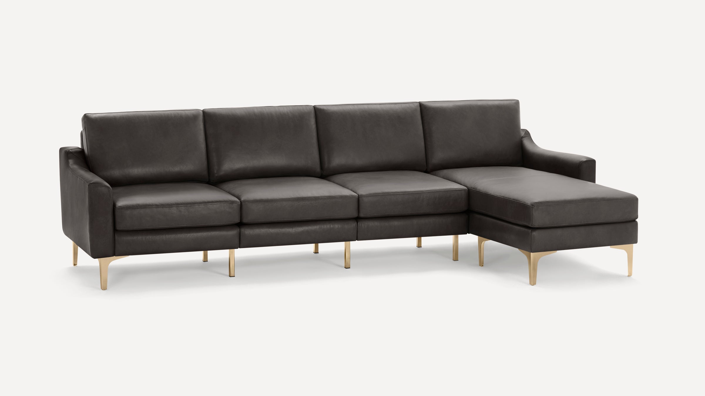 Modern dark gray leather sectional sofa with sleek gold metal legs and chaise lounge on the right side, set against a white background.