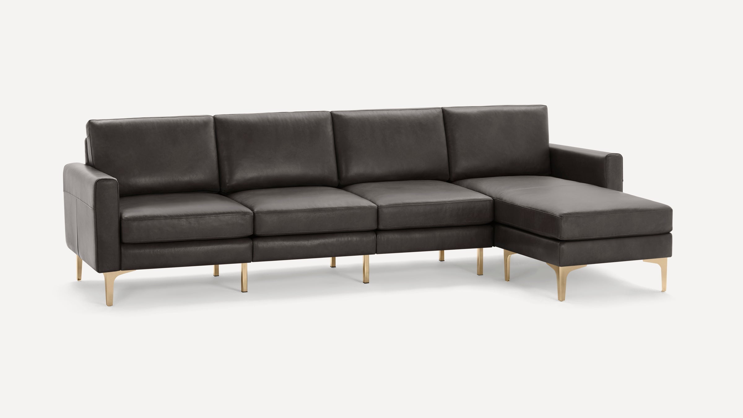 Modern charcoal gray leather sectional sofa with clean lines and gold metal legs, featuring a chaise lounge on the right side.