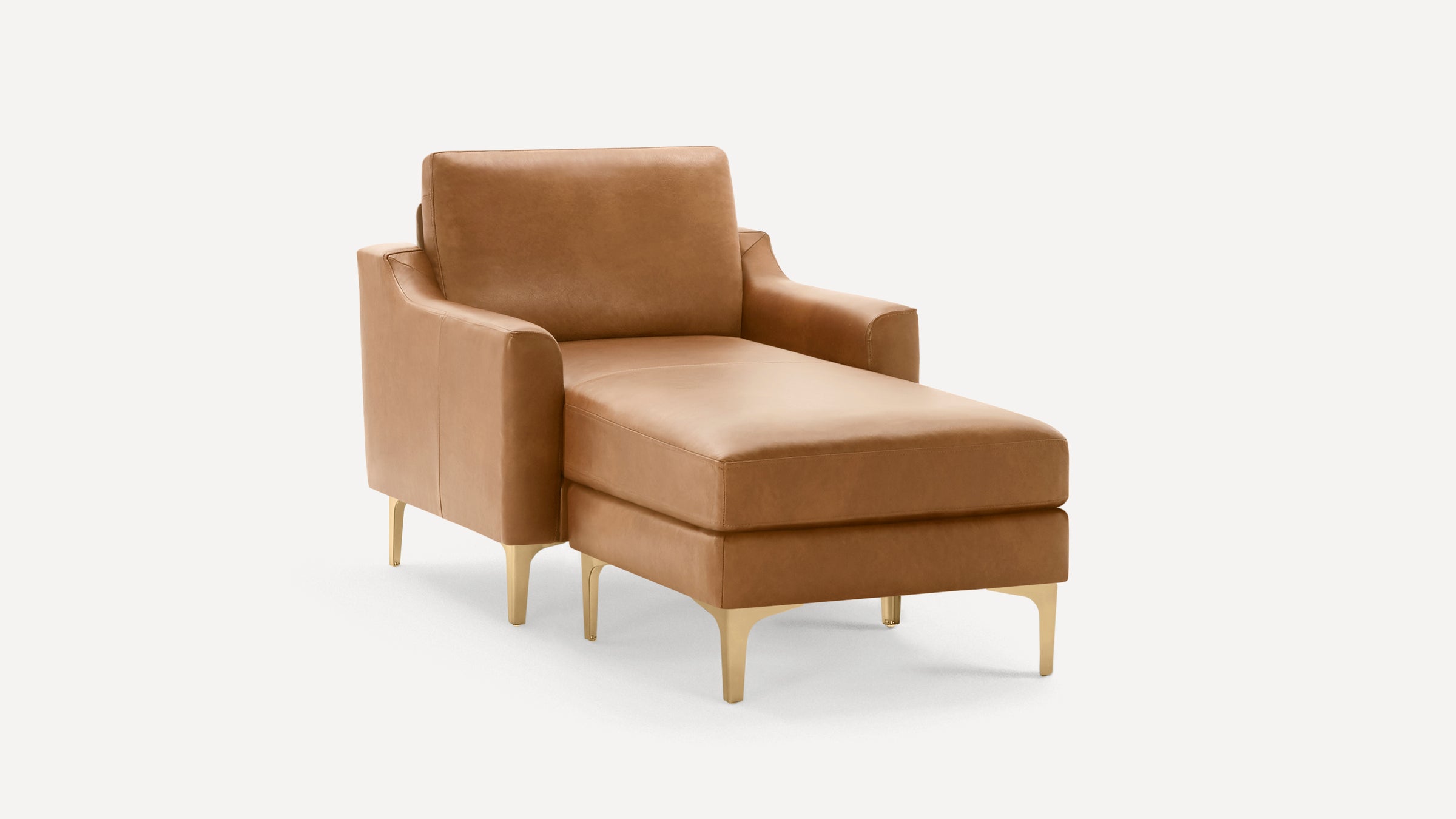 Modern tan leather chaise lounge chair with armrests and gold metal legs on a white background.