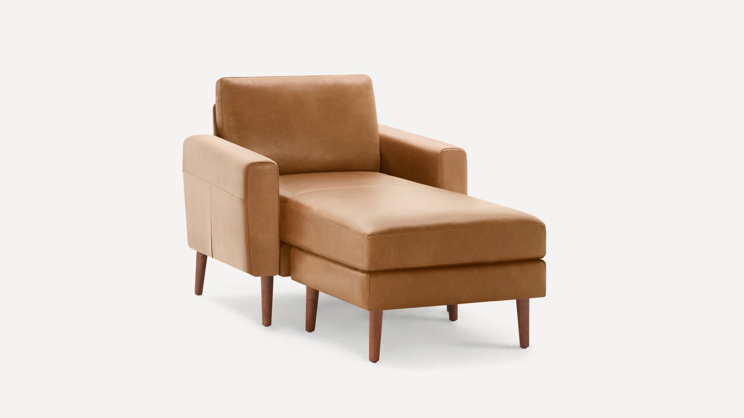Mid-century modern tan leather chaise lounge chair with wooden tapered legs and boxy arms on white background.