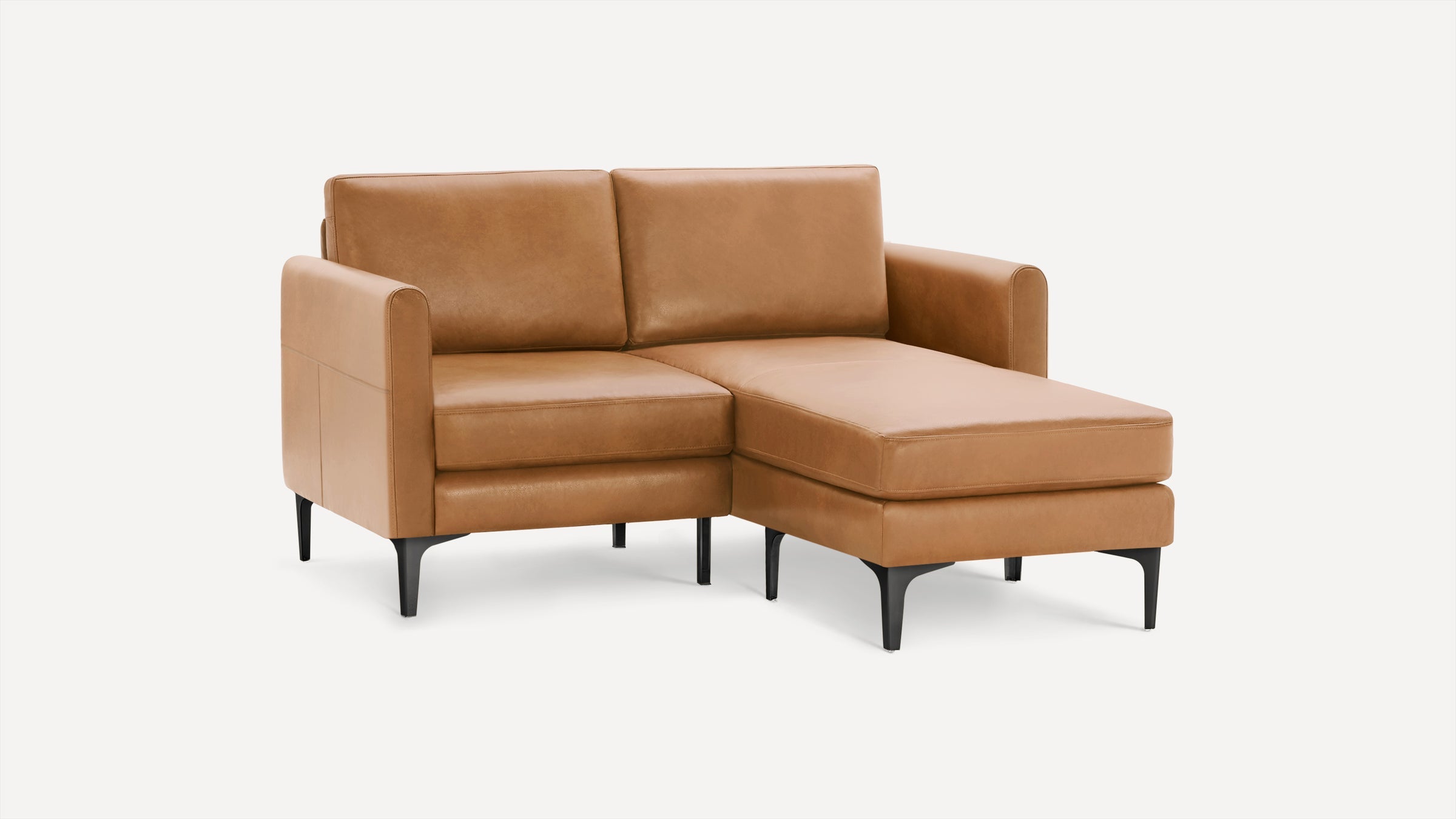 Modern tan leather sectional sofa with clean lines, black metal legs, and a right chaise lounge against a plain white background.