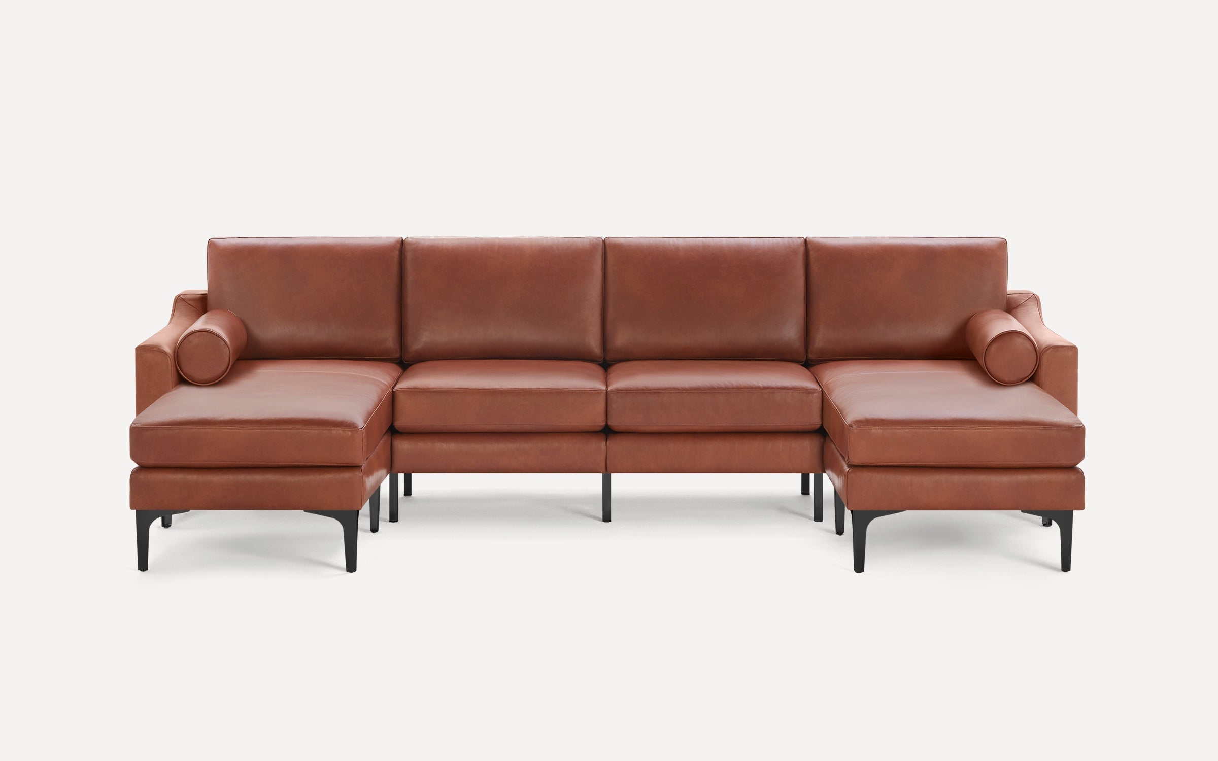 Modern brown leather sectional sofa with two chaise lounges, cylindrical bolsters, and sleek black metal legs.