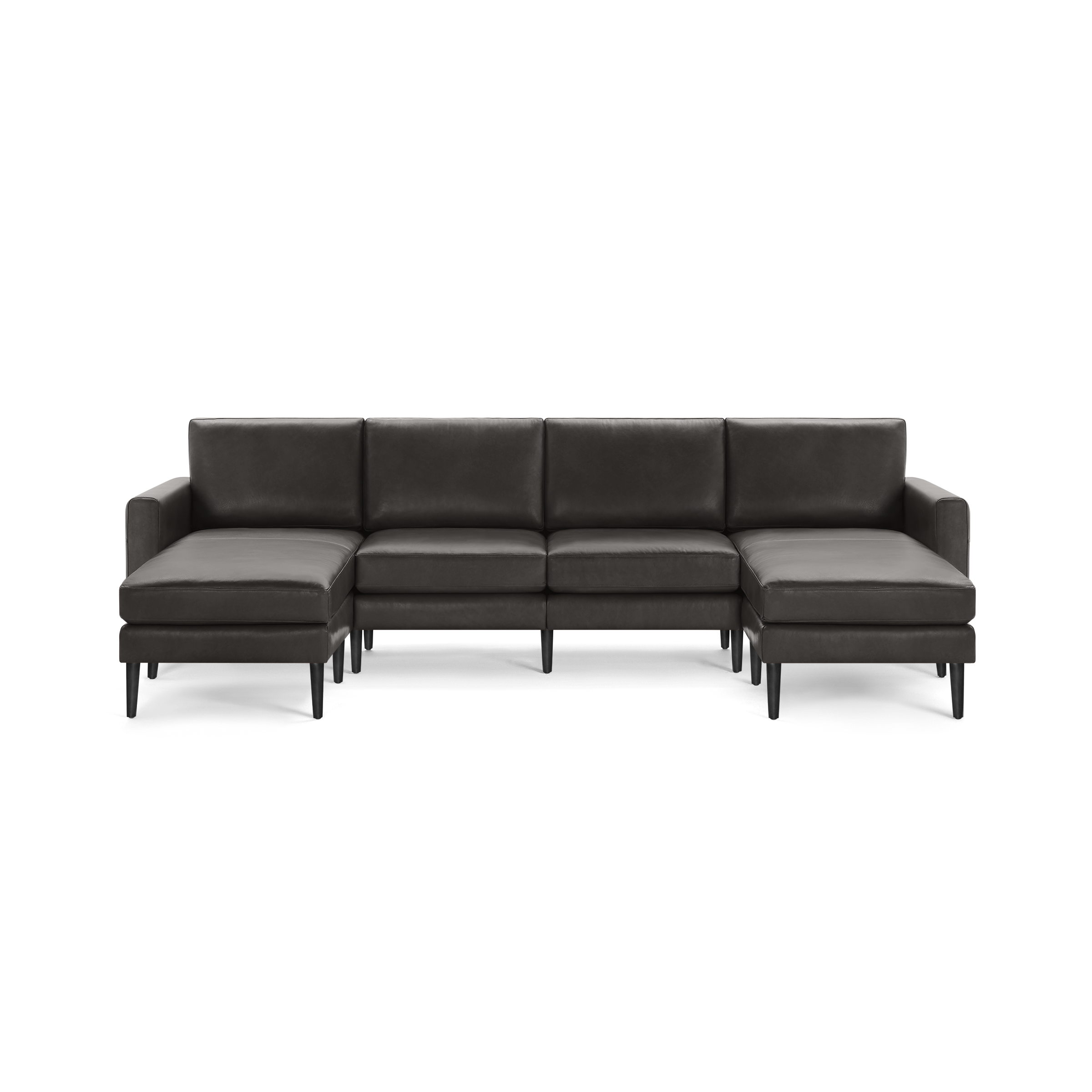Modern dark gray leather sectional sofa with chaise lounges on both ends and sleek black legs.