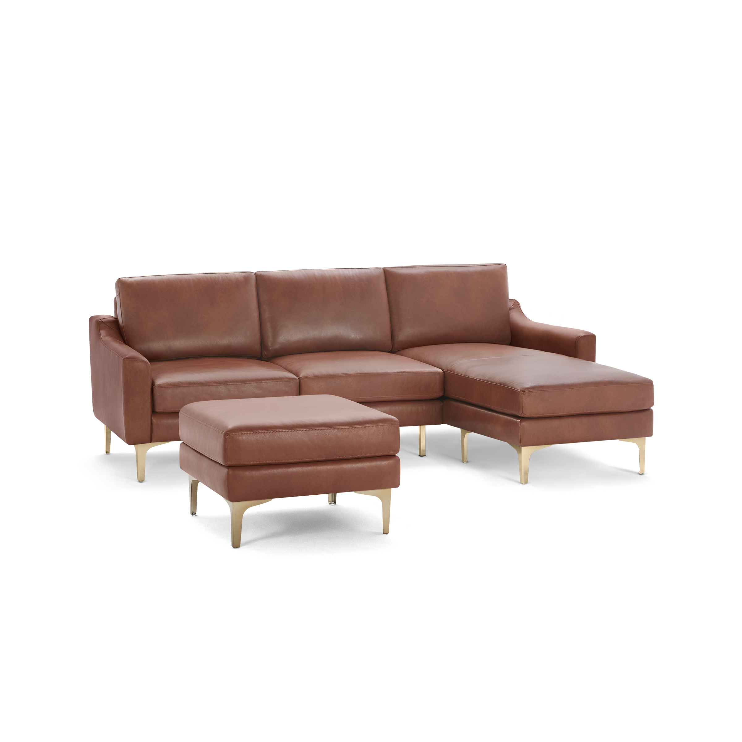 Modern brown leather sectional sofa with matching ottoman, featuring gold metal legs and plush cushions.