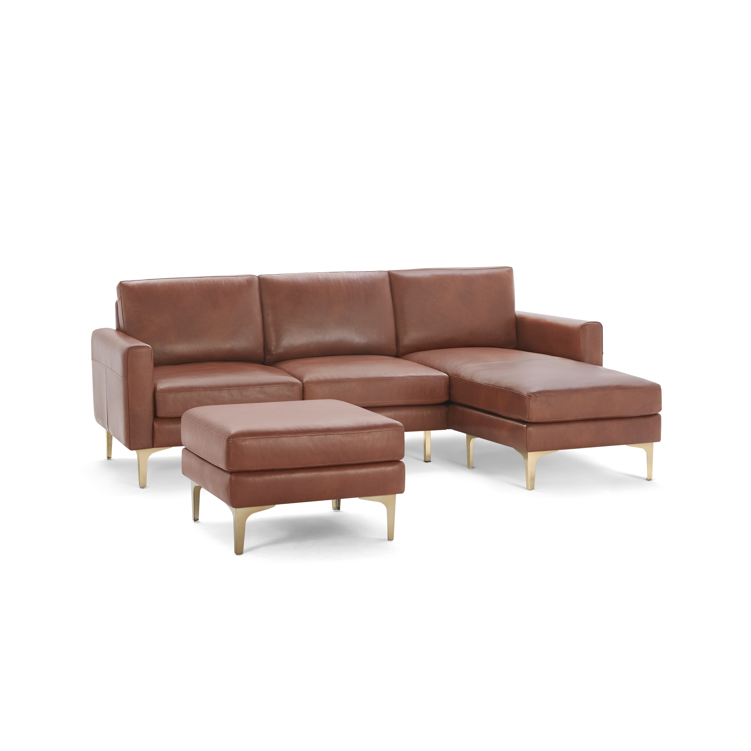 Brown leather sectional sofa with chaise lounge and matching ottoman, featuring sleek gold metal legs.