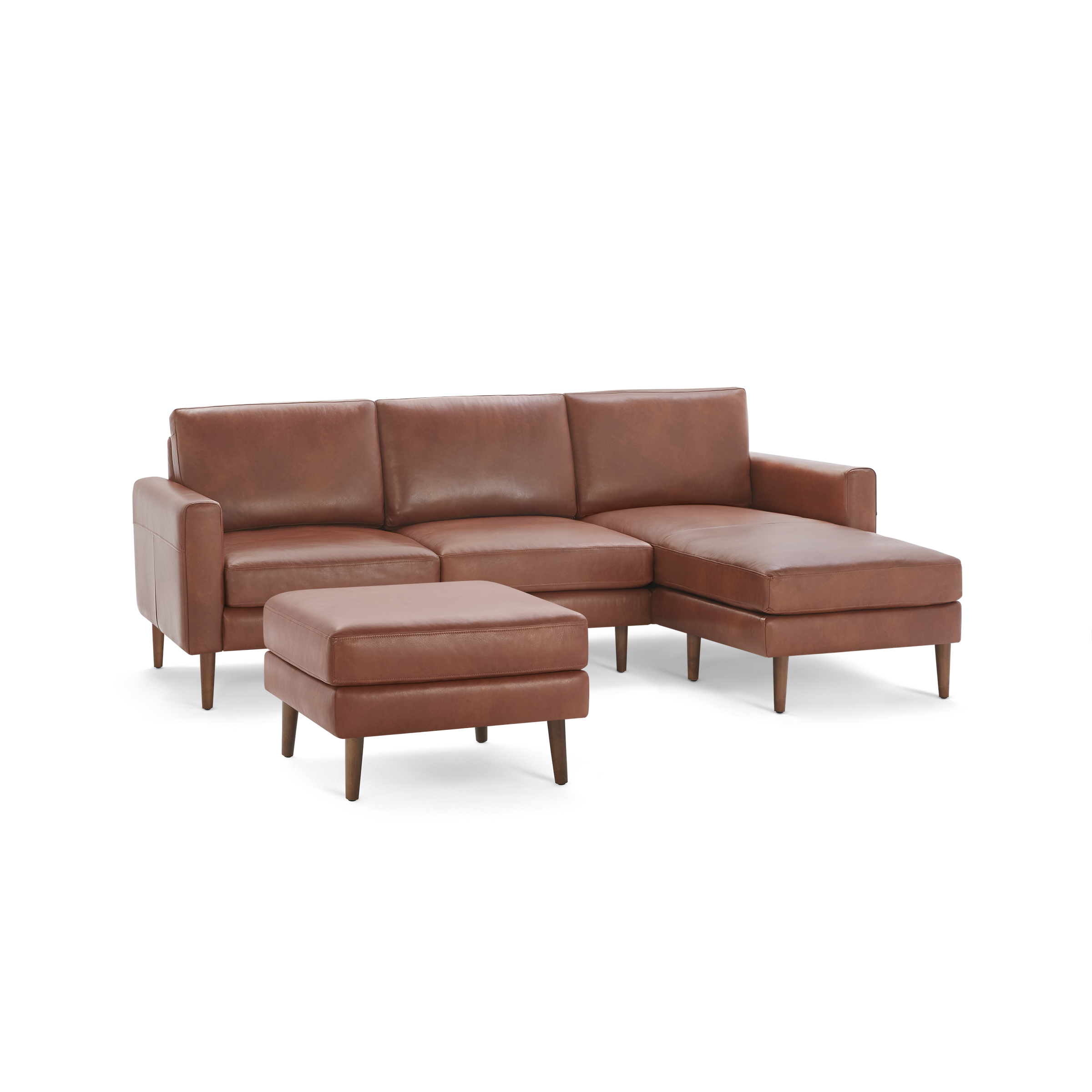 Brown leather sectional sofa with wooden legs and a matching ottoman, featuring clean lines and modern design.