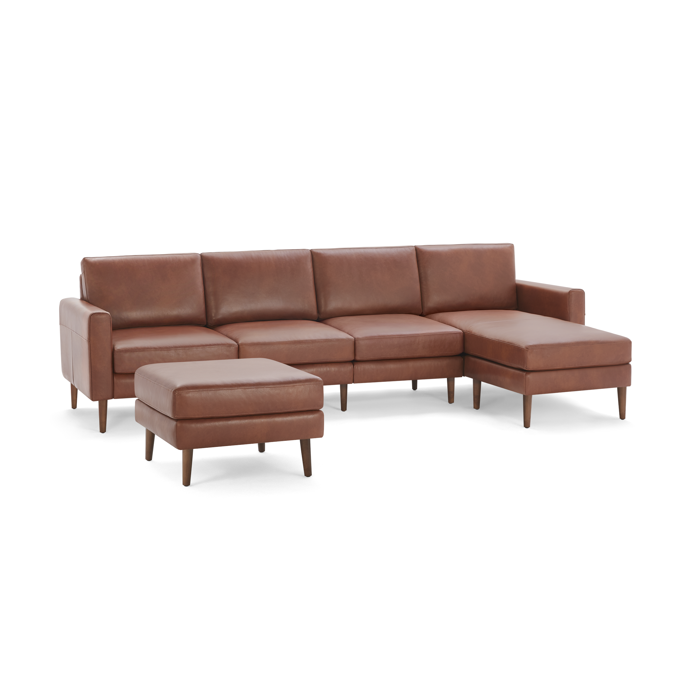 Modern sectional sofa with chaise lounge and matching ottoman, upholstered in brown leather with wooden legs.