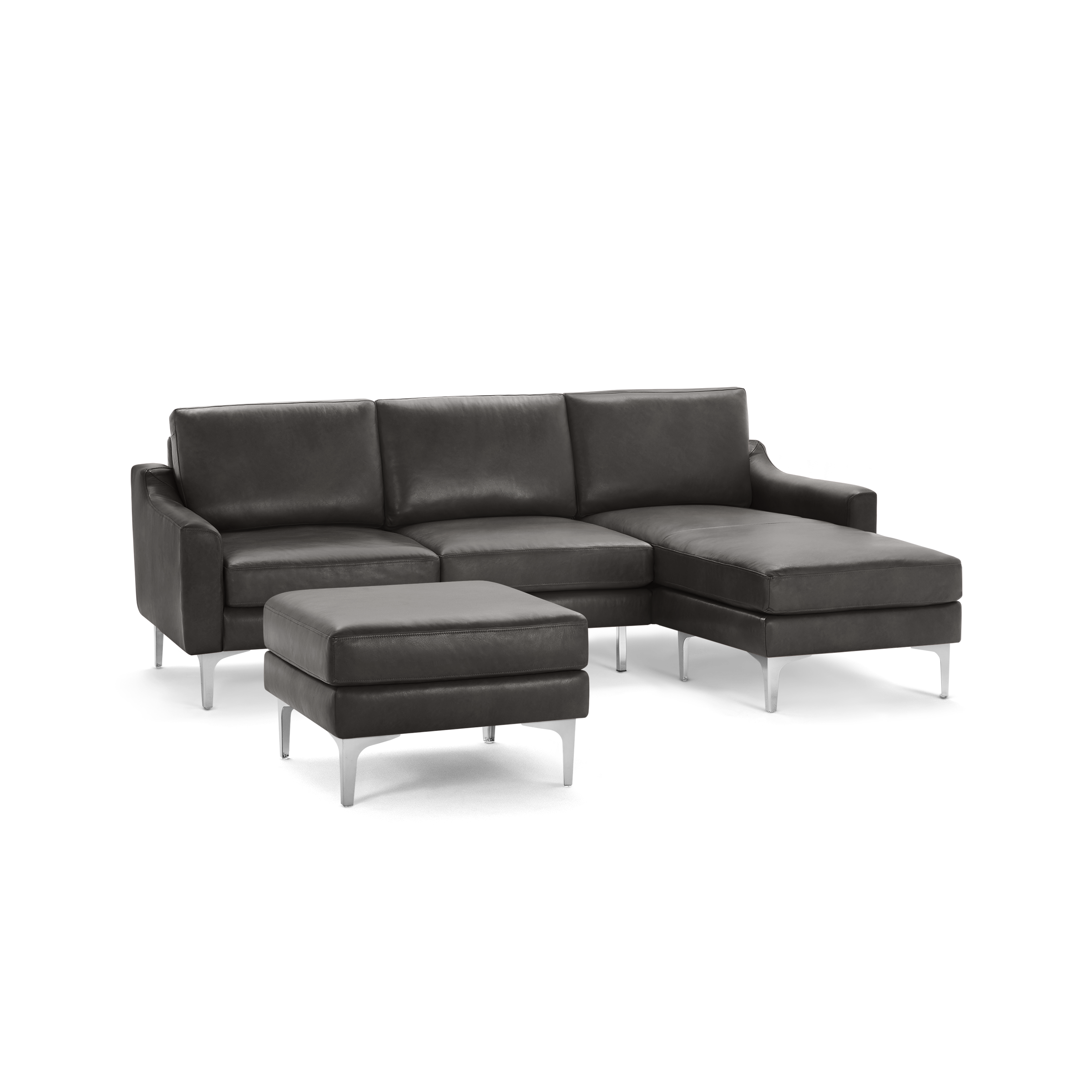 Modern dark gray leather sectional sofa with sleek metal legs and matching cushioned ottoman.