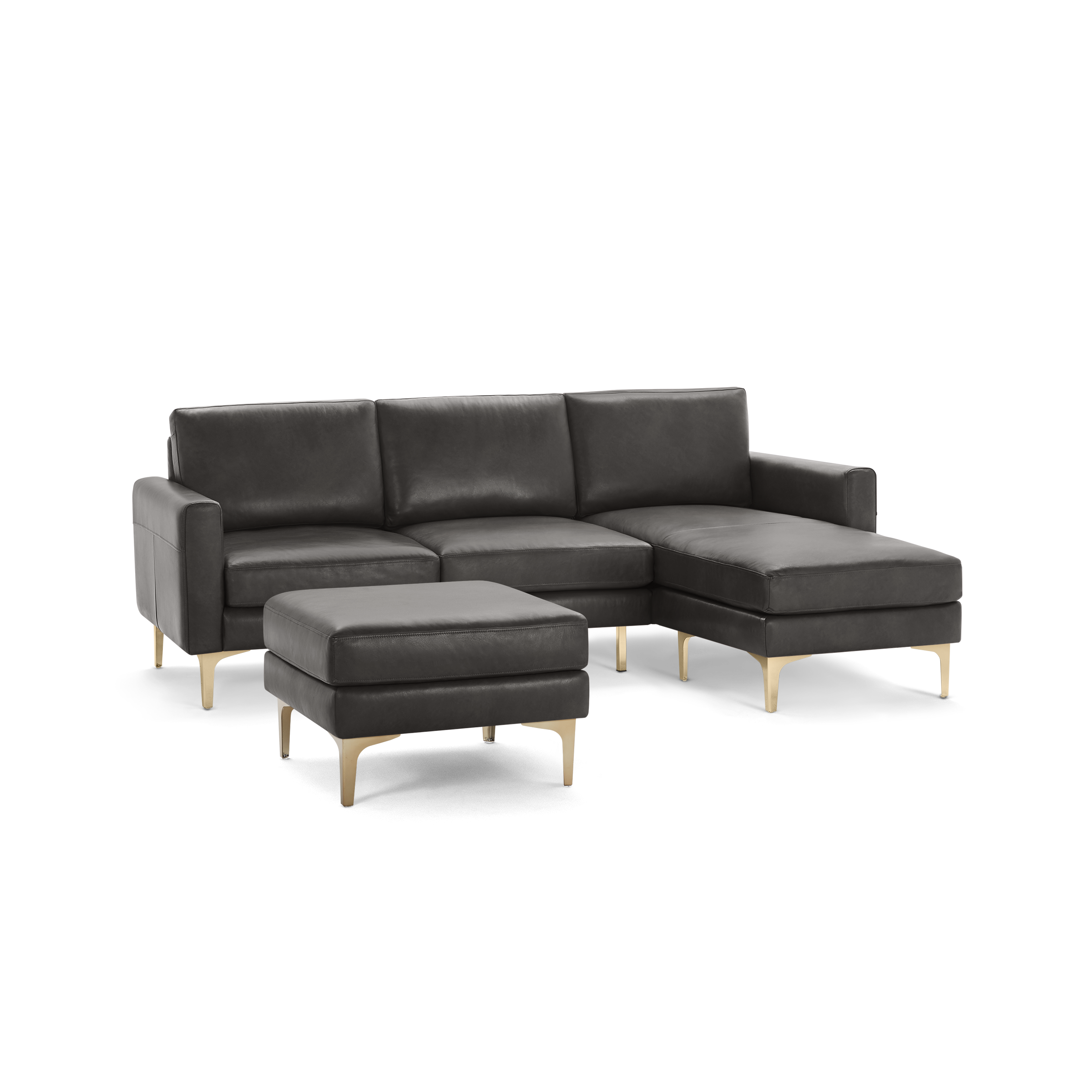 Dark gray leather sectional sofa with chaise lounge and matching ottoman, featuring sleek gold metal legs.