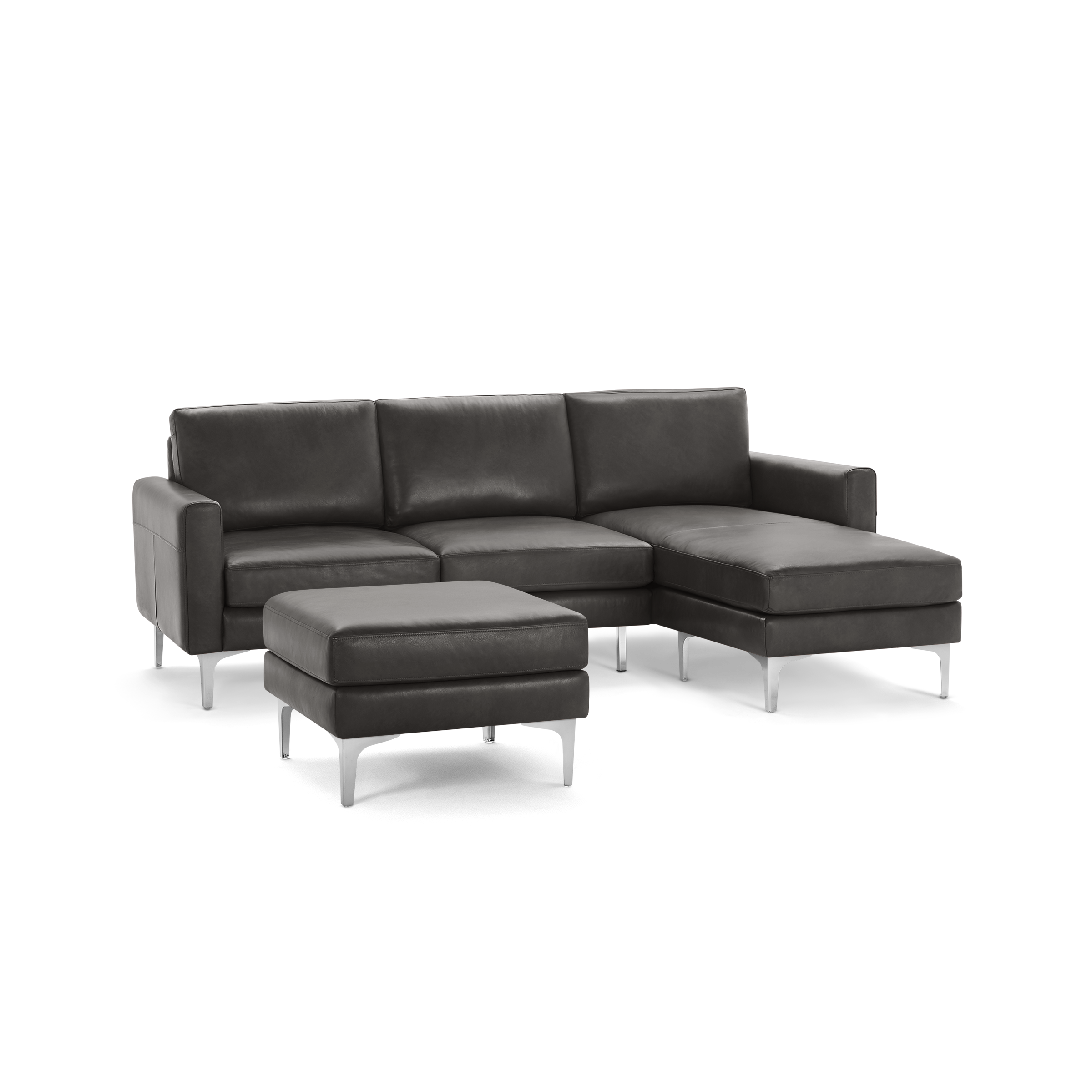 Dark gray leather sectional sofa with chaise lounge and matching ottoman, supported by sleek silver metal legs.