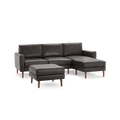 Dark gray leather sectional sofa with matching ottoman, wooden legs, and modern design spacious chaise lounge on right side.