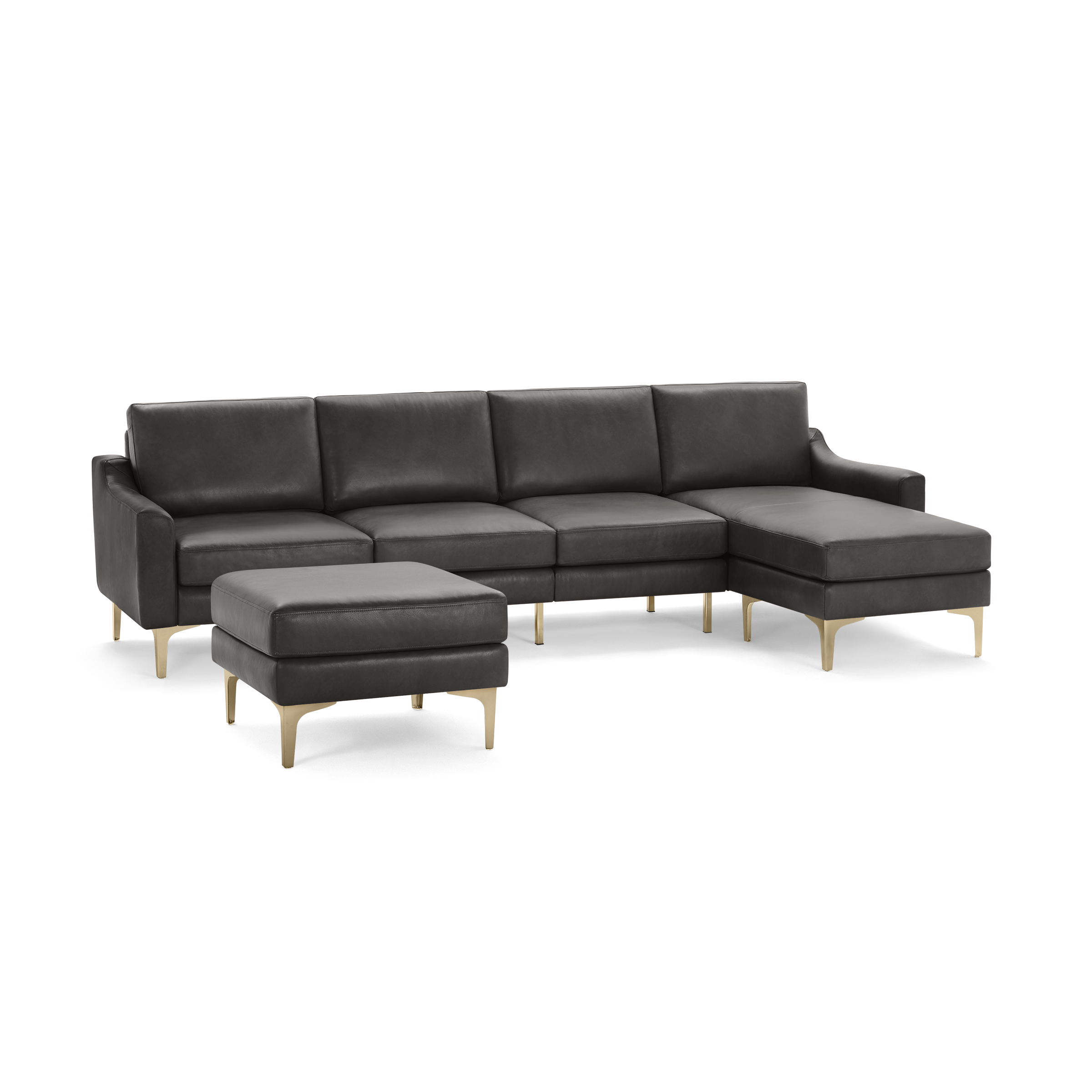 Modern dark gray leather sectional sofa with clean lines, gold metal legs, and matching ottoman isolated on black background.