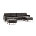 Dark gray modern sectional sofa with wooden legs and matching ottoman, featuring clean lines and cushioned seats.