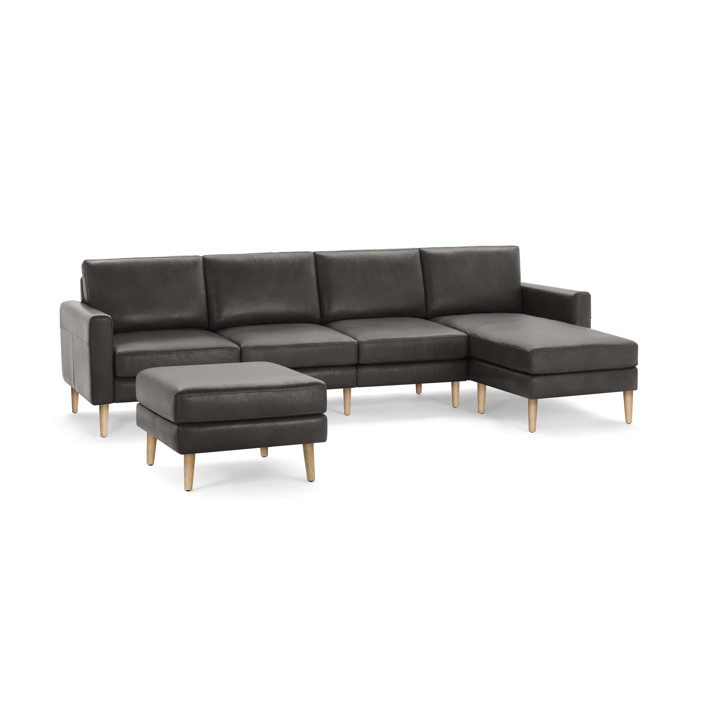Dark gray sectional sofa with chaise lounge and matching ottoman, featuring wooden legs and modern design.
