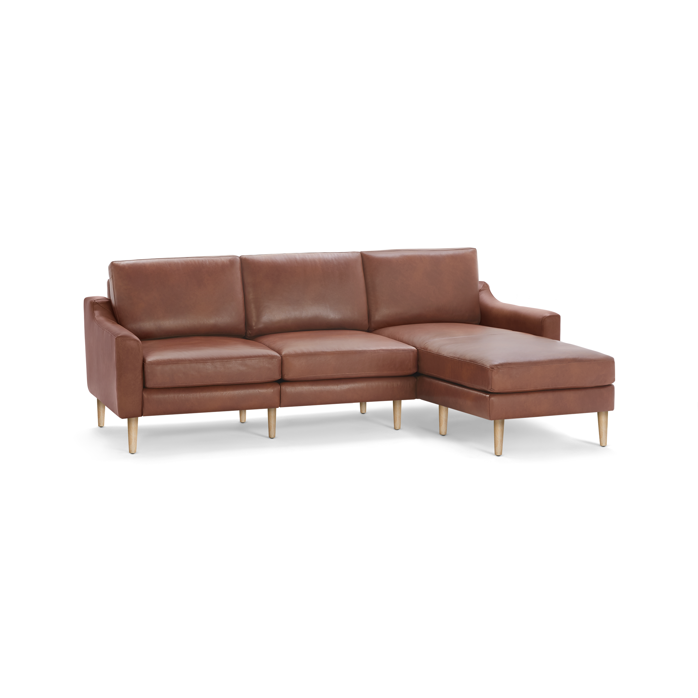 Brown leather sectional sofa with three seat cushions, wooden legs, and chaise lounge on the right side.