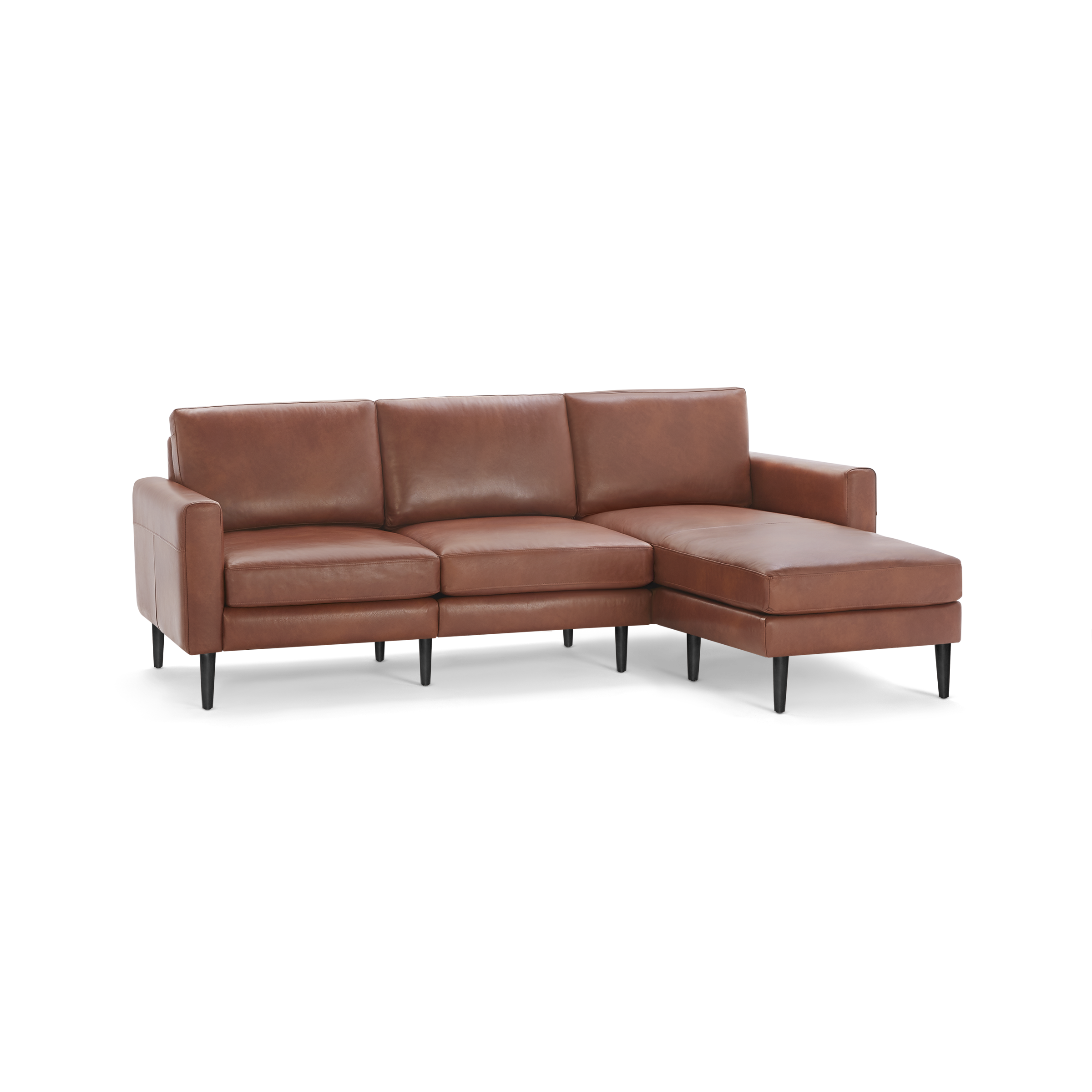 Modern sectional sofa in warm brown leather with three seat cushions, right chaise lounge, and black tapered wooden legs.