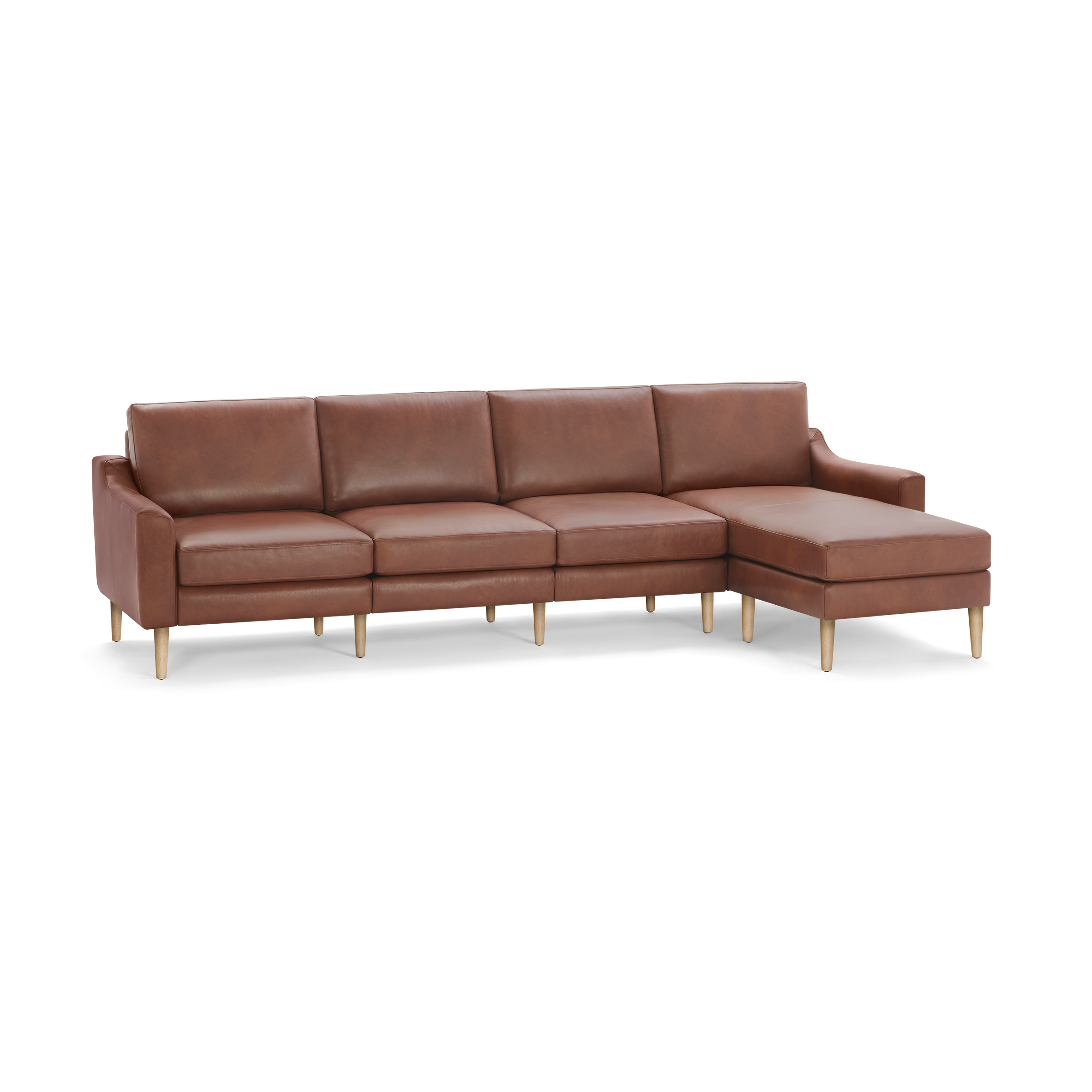 Modern brown leather sectional sofa with wooden legs, featuring four seat cushions and a chaise lounge on the right side.