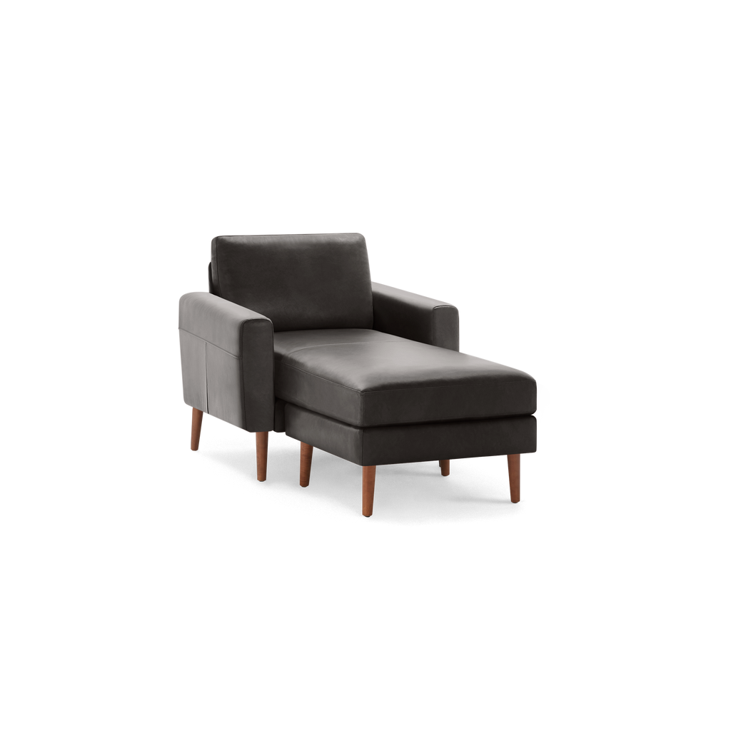 Modern dark gray chaise lounge chair with square armrests and wooden tapered legs, designed for comfortable lounging.