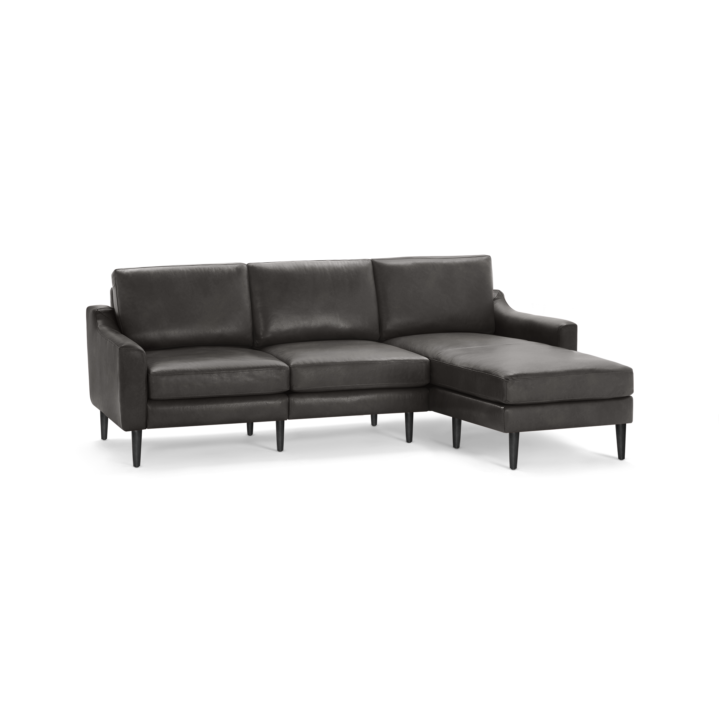 Dark gray modern leather sectional sofa with chaise lounge on right side and tapered wooden legs.