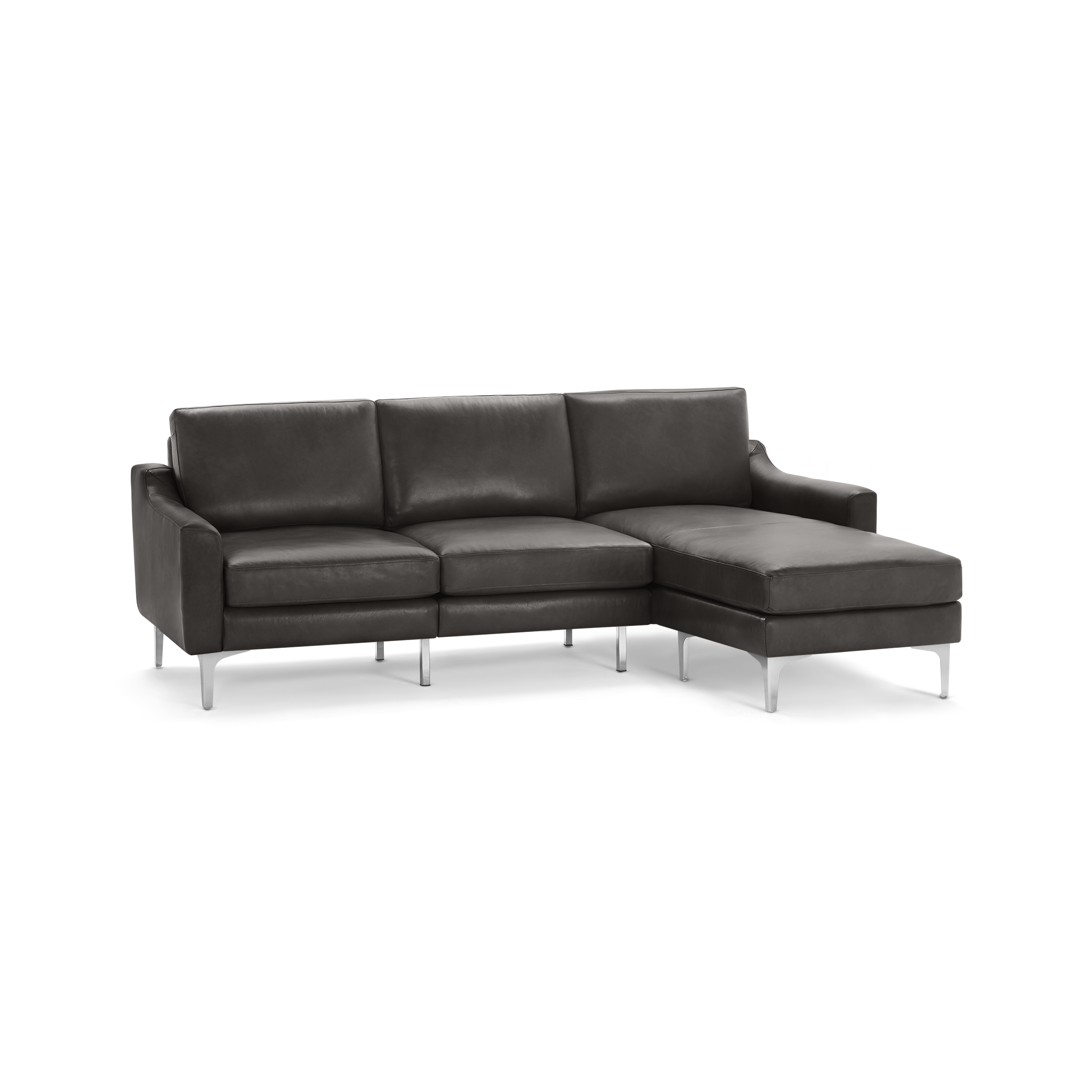 Modern dark gray leather sectional sofa with chaise lounge on the right side and sleek metal legs.