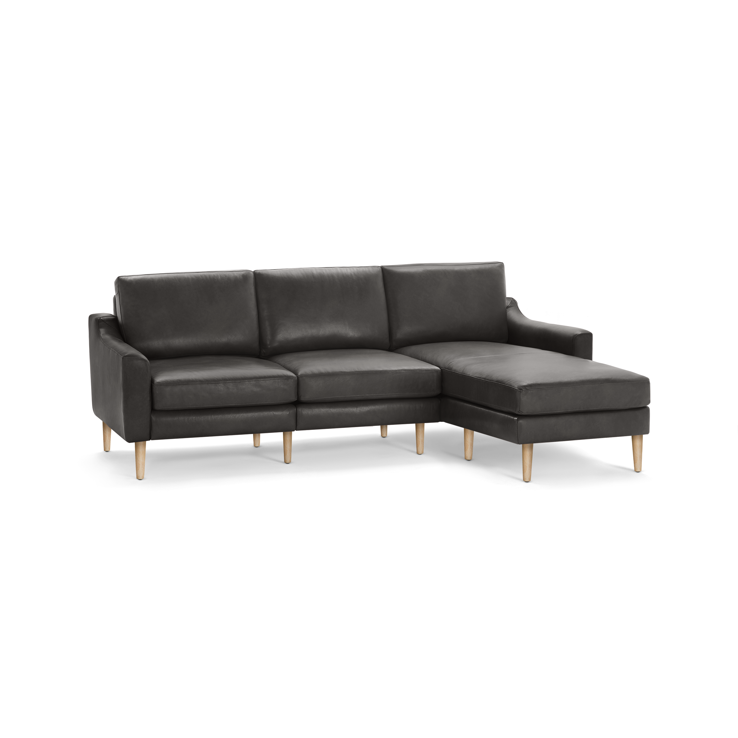 Dark gray leather sectional sofa with three cushioned seats and a chaise lounge on wooden legs.