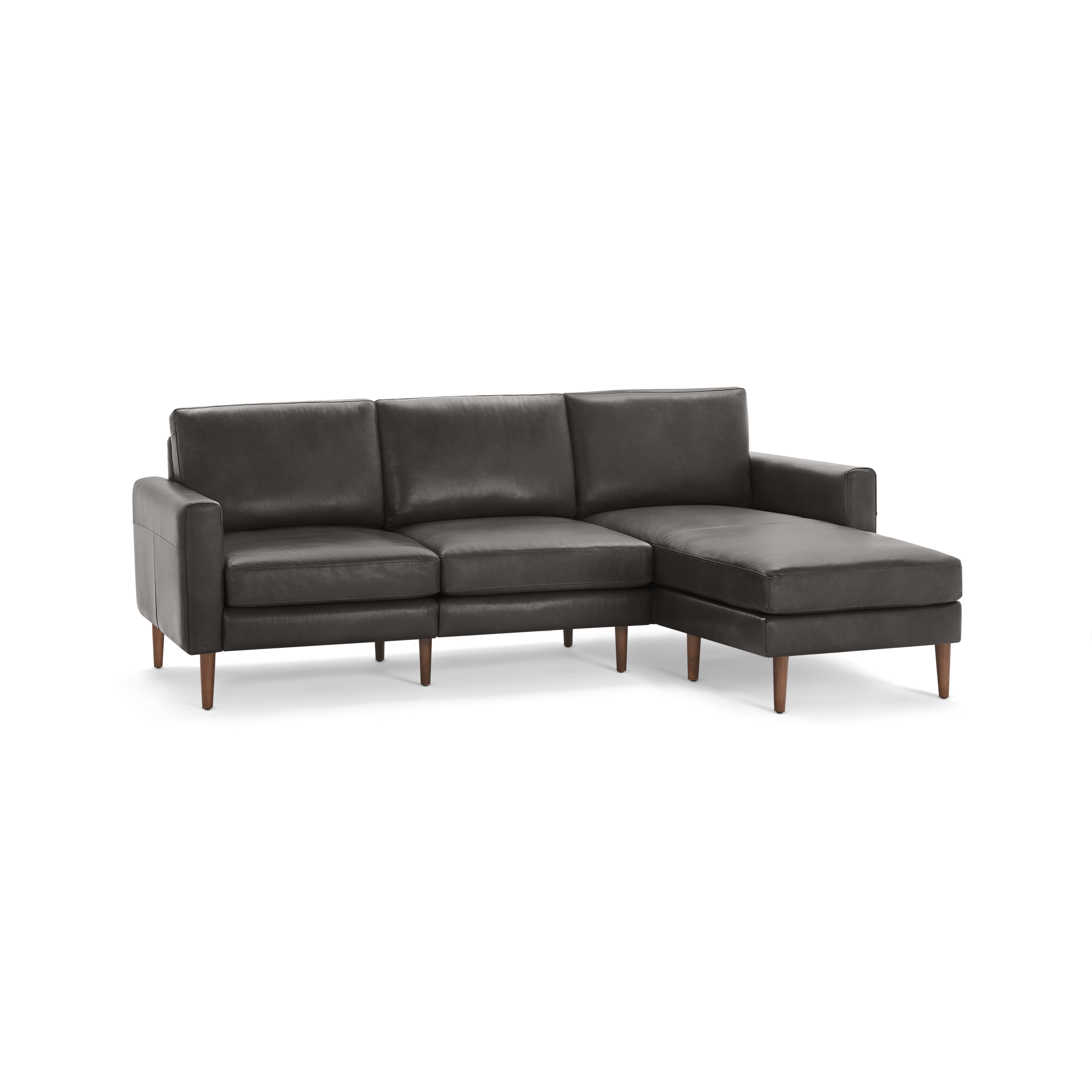 Dark gray leather sectional sofa with three cushions and wooden legs, featuring a chaise lounge on the right side.