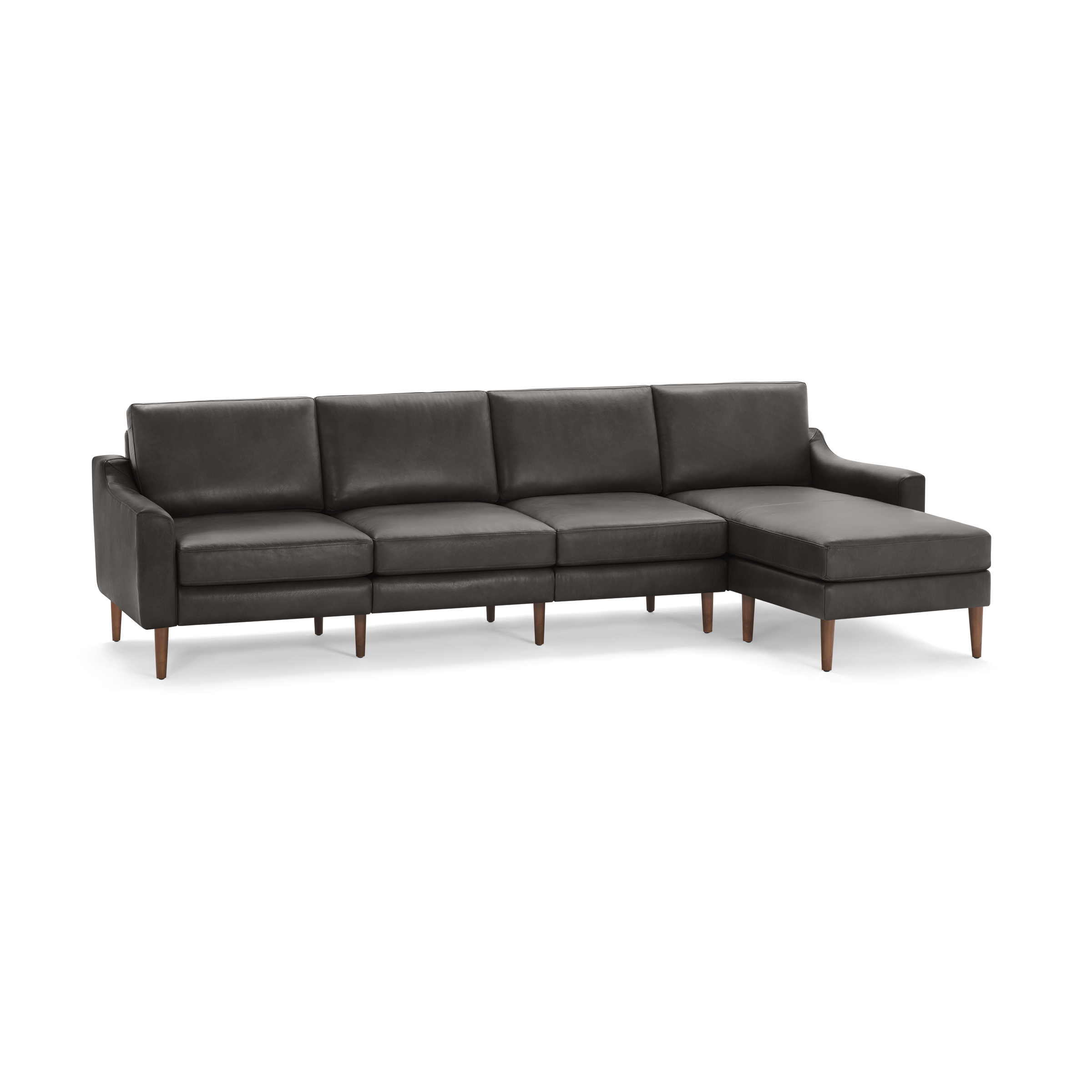 Modern dark gray leather sectional sofa with wooden legs and chaise lounge on the right side.