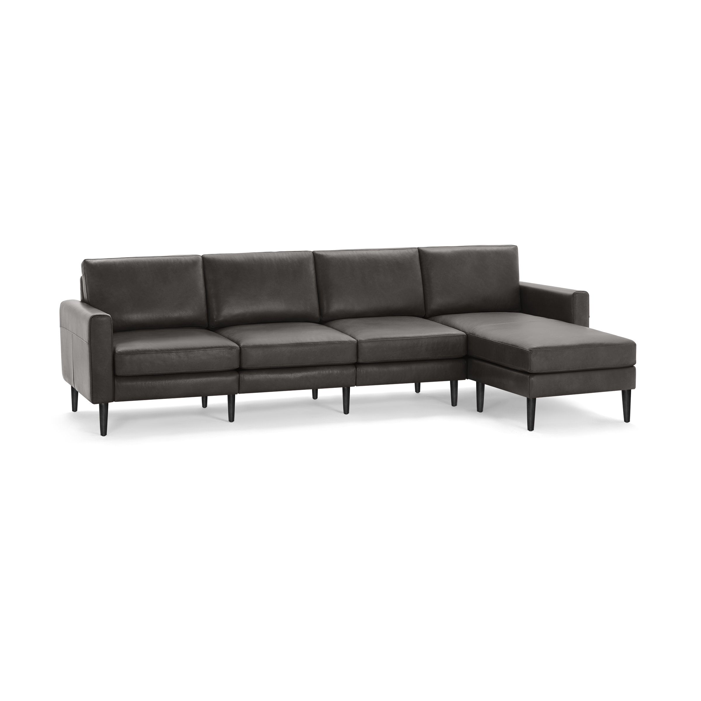 Dark gray leather sectional sofa with clean lines, cushioned seats, and a chaise lounge on the right side, supported by slender black legs.