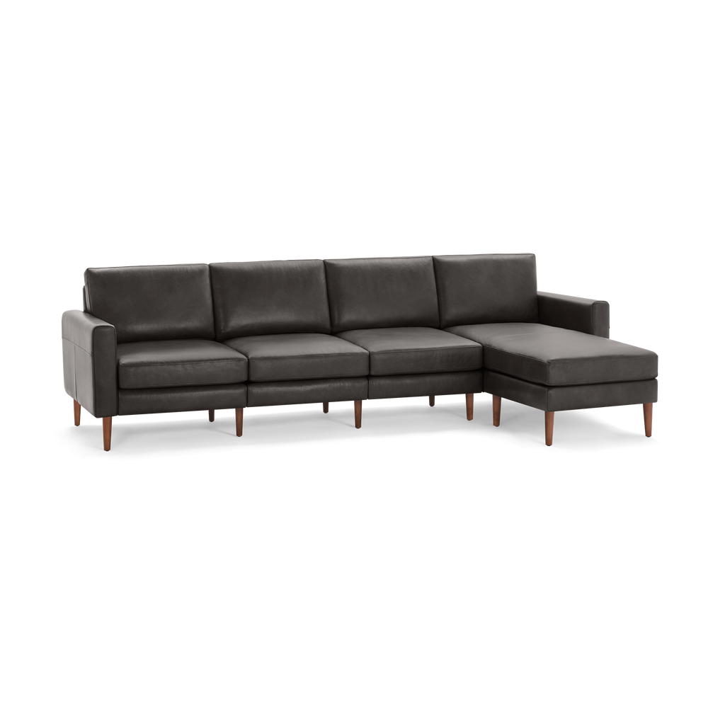 Modern dark gray leather sectional sofa with chaise lounge and wooden legs, offering sleek and comfortable seating for living rooms.