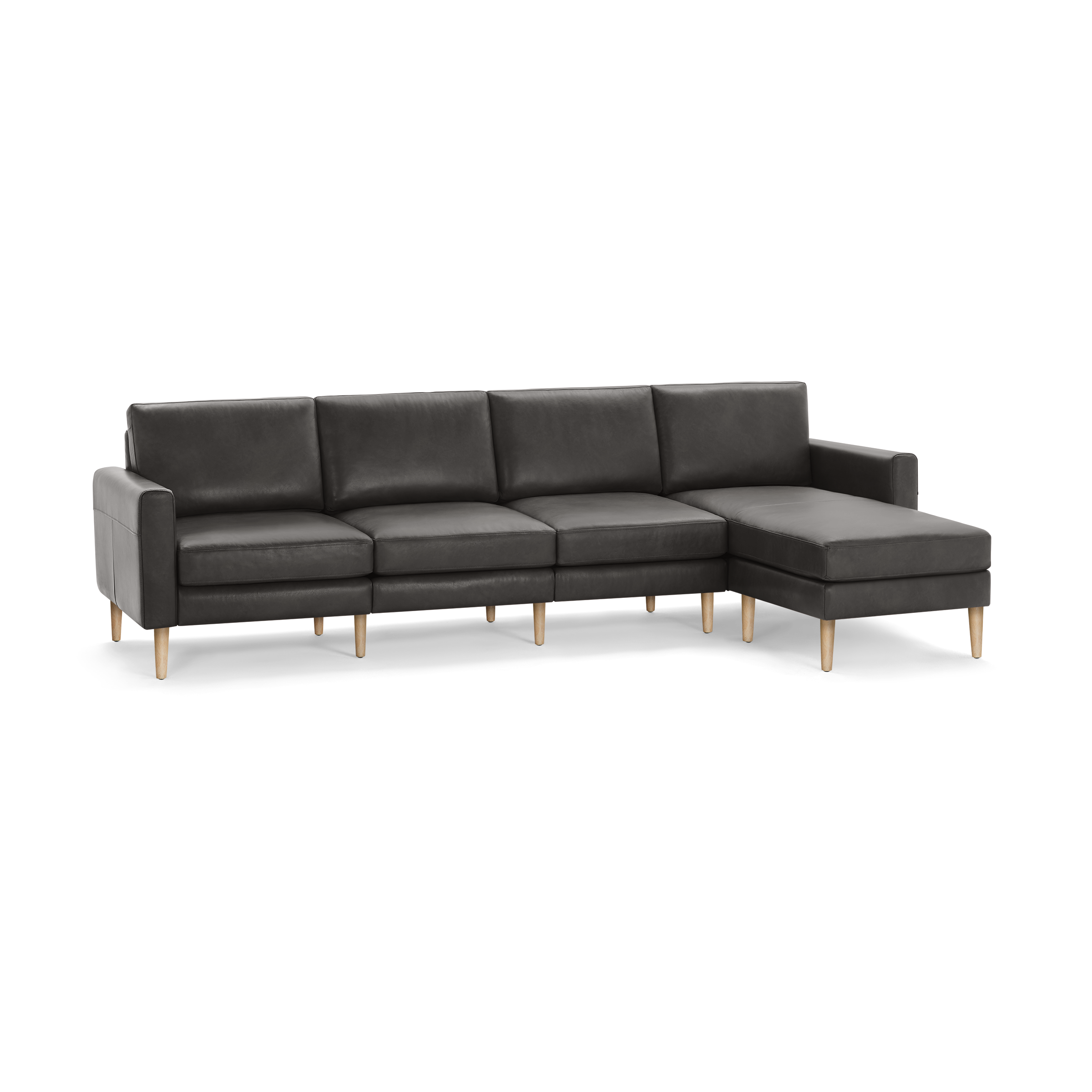 Modern dark gray leather sectional sofa with wooden legs, featuring three seats and an extended chaise lounge on the right side.