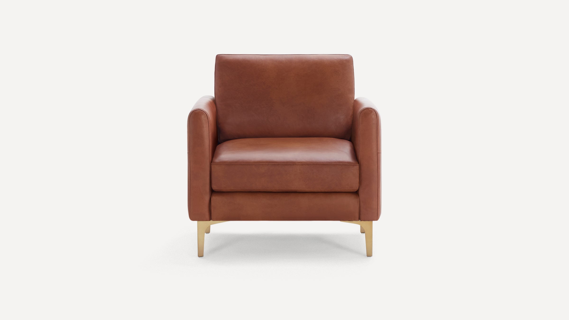 Front view of a modern brown leather armchair with square arms and gold metal legs on a white background.