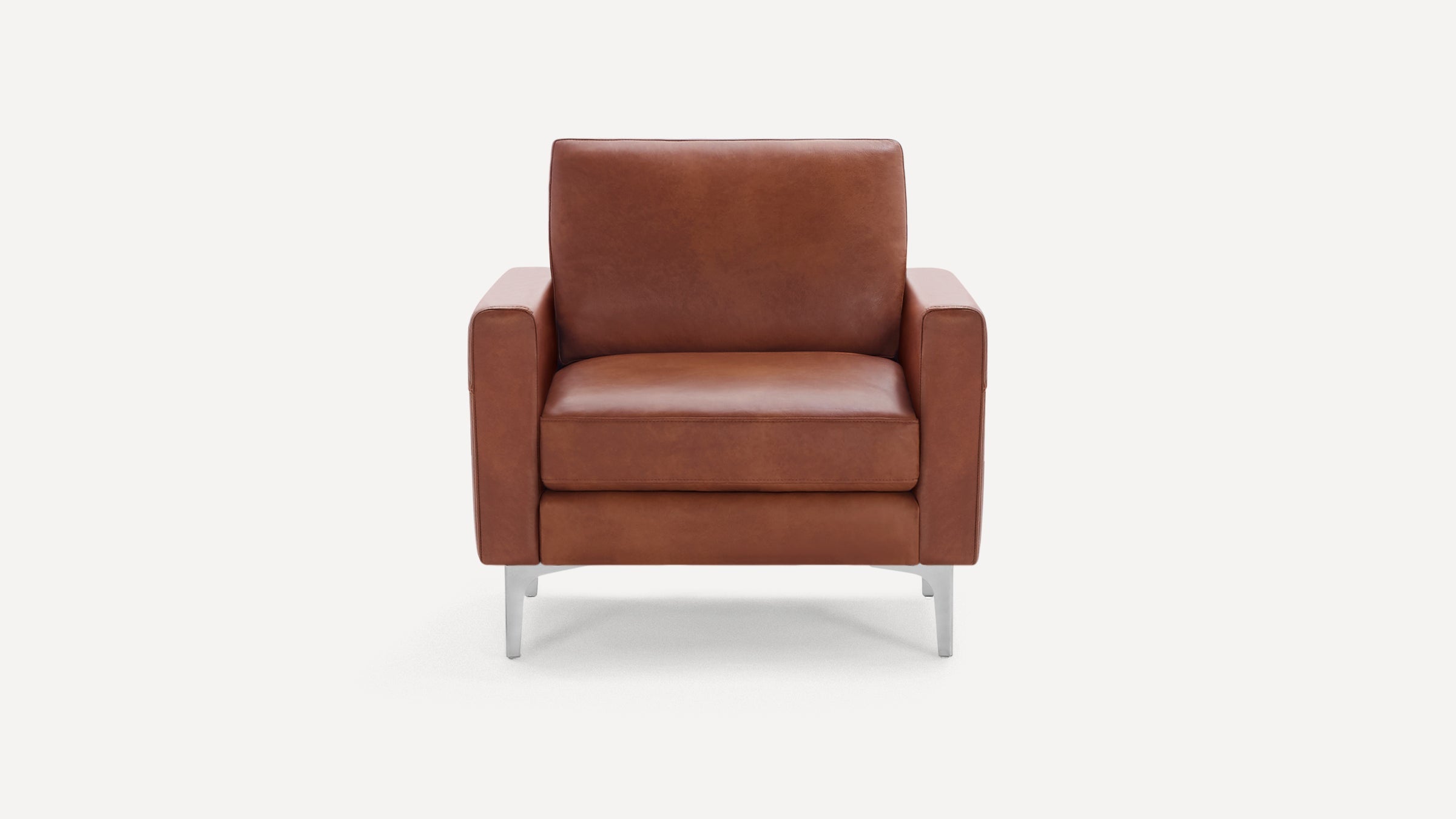 Front view of a modern brown leather armchair with square arms and silver metal legs on a white background.