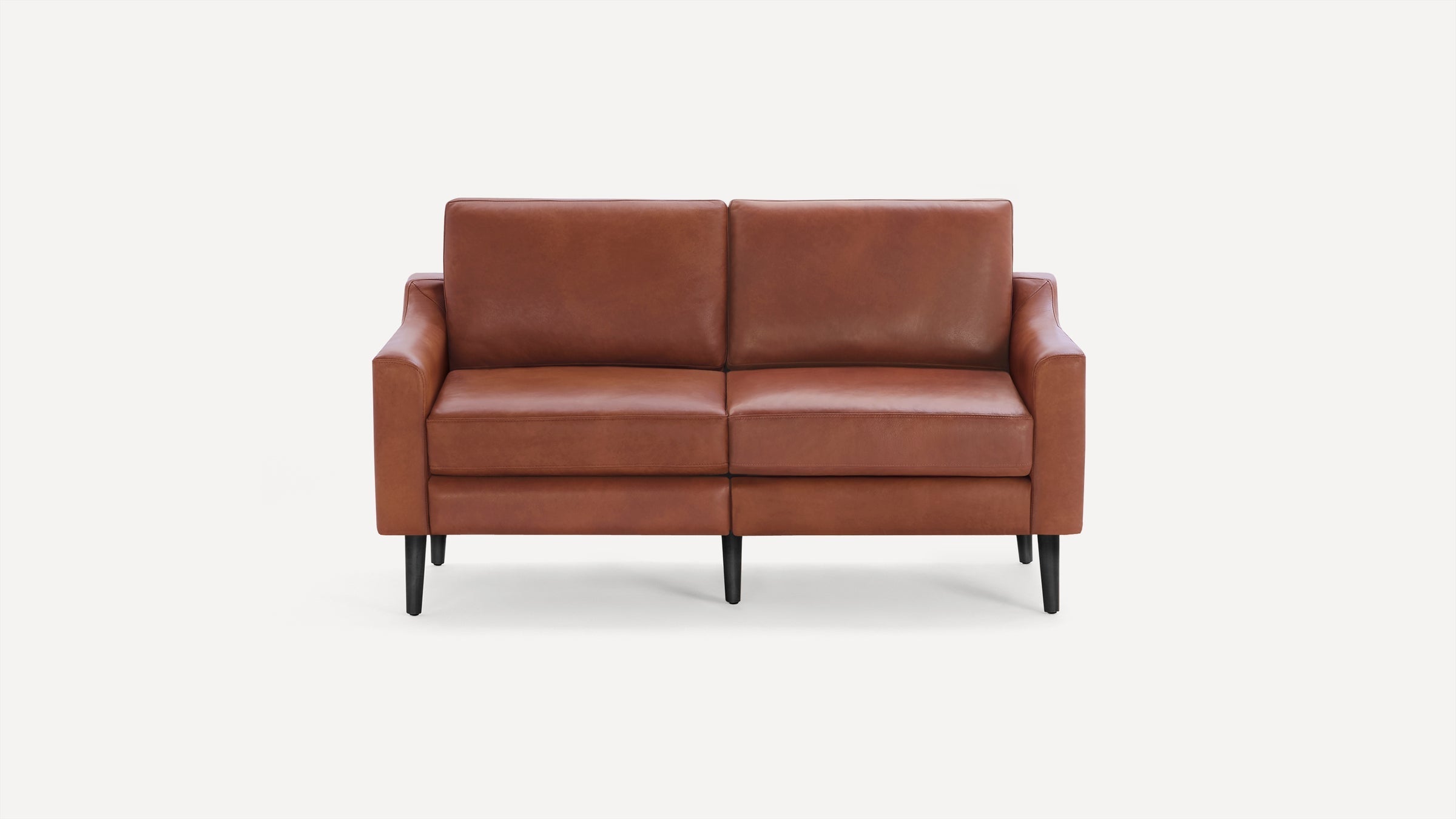 Modern two-seater brown leather sofa with clean lines, plush cushions, and black tapered legs, set against a white background.