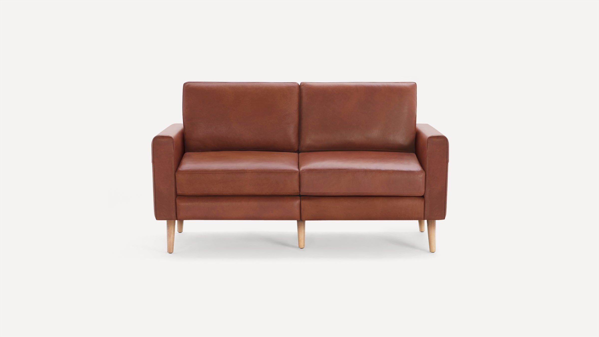 Modern two-seater sofa upholstered in brown leather with wooden tapered legs and clean, minimalist design.