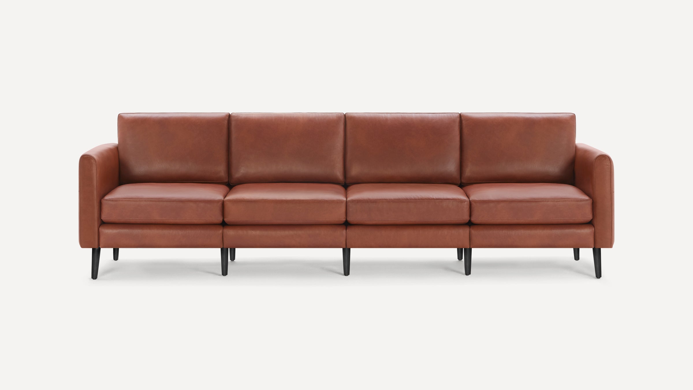 Four-seater modern brown leather sofa with clean lines, cushioned seats and backs, and slim black tapered legs.