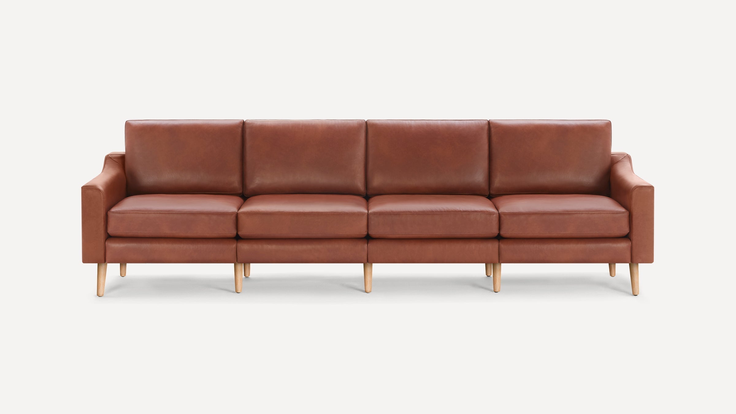Four-seater modern sofa with brown leather upholstery and light wooden legs, featuring clean lines and cushioned seats and backs.