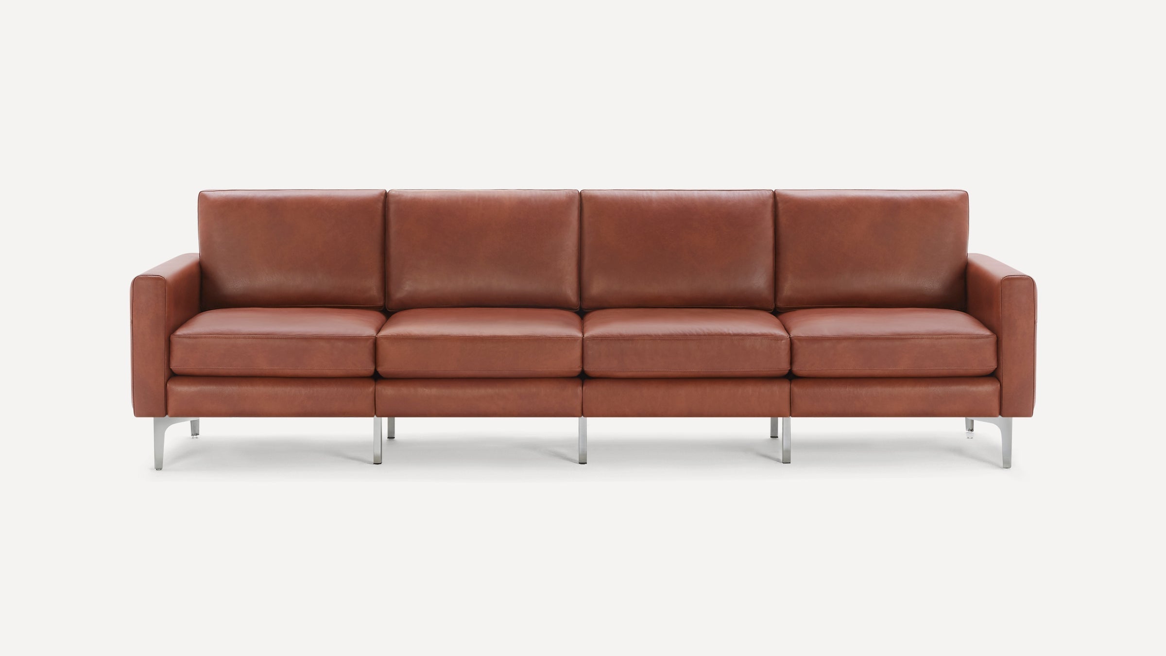 Modern four-seater sofa with smooth brown leather upholstery and sleek silver metal legs on white background.