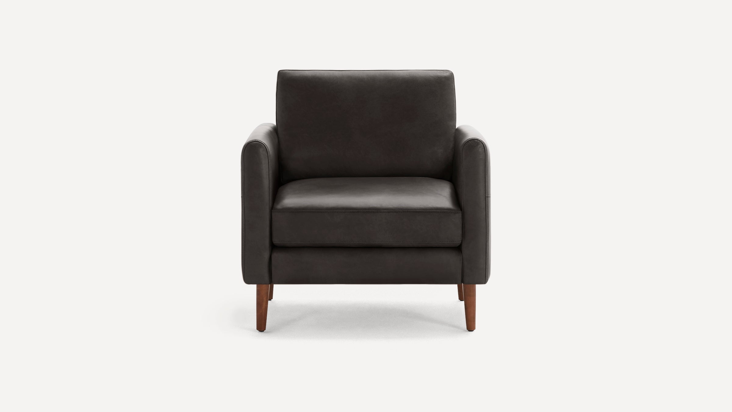 Front view of a modern, dark gray upholstered armchair with wooden legs and squared armrests.