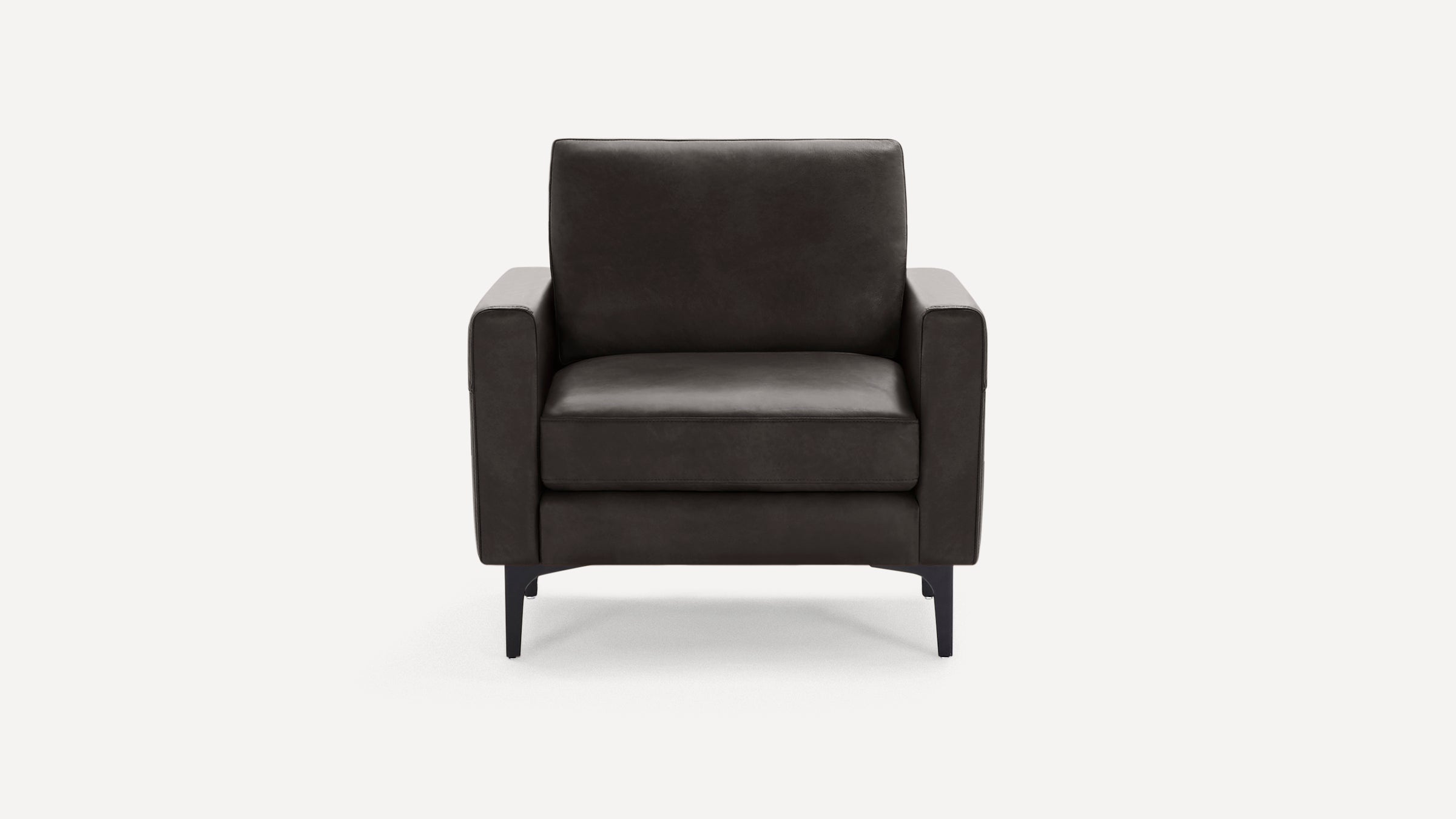 Modern dark gray leather armchair with straight armrests, cushioned seat and back, supported by slim black metal legs.