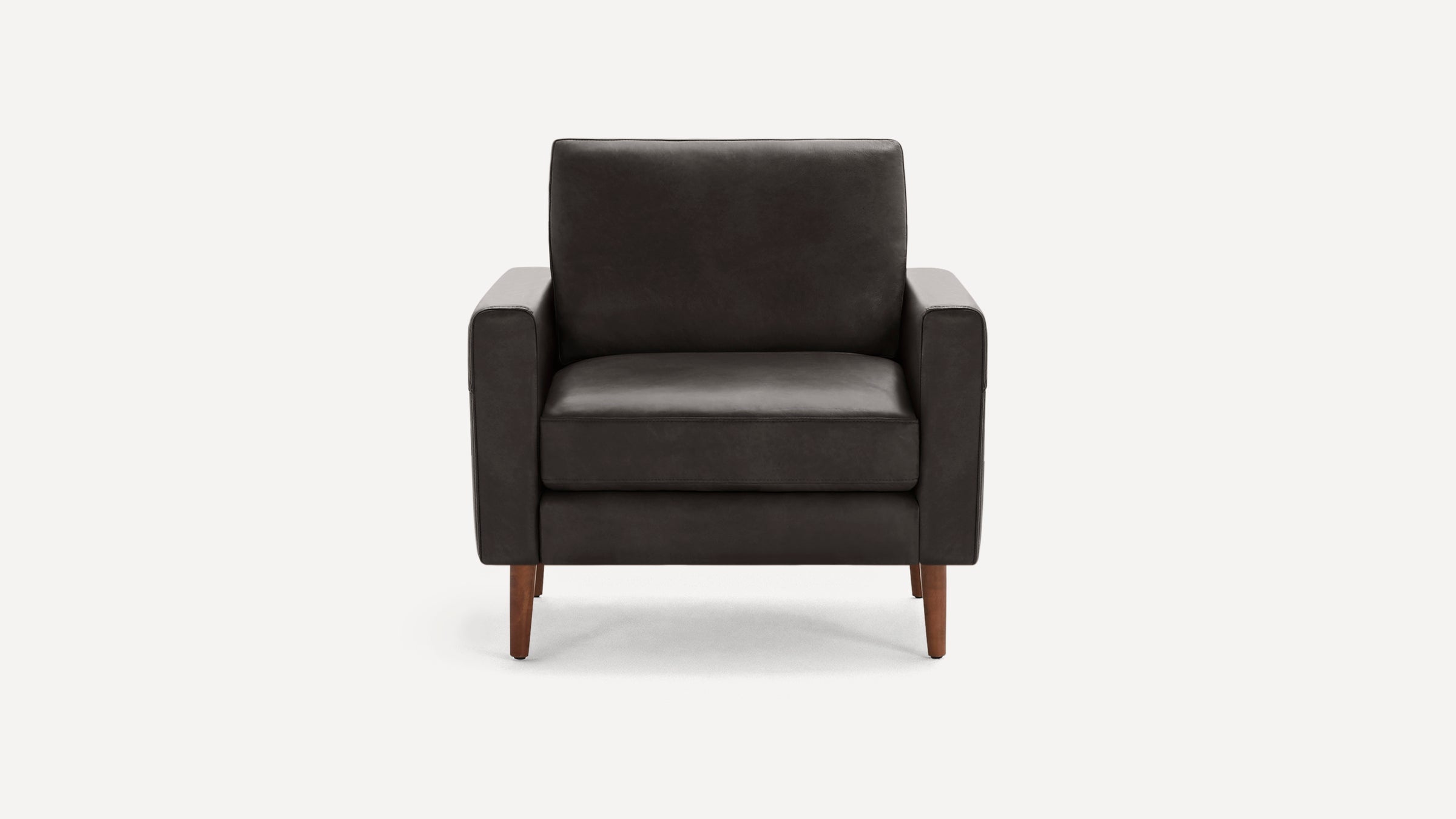 Front view of a modern, dark gray leather armchair with wooden legs and clean, straight armrests.