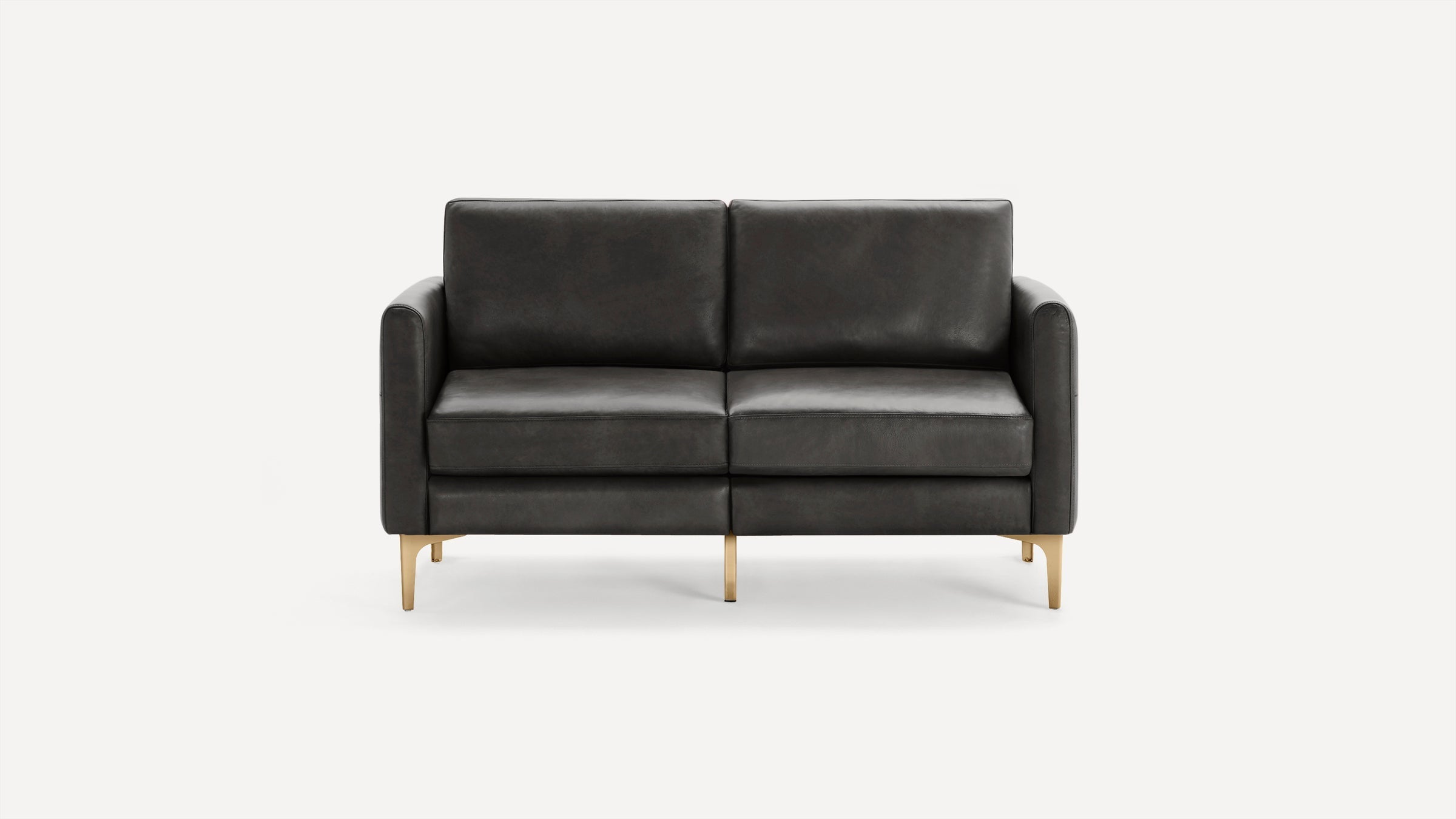 Modern dark gray leather loveseat with clean lines, cushioned seats, and gold-toned metal legs on a white background.