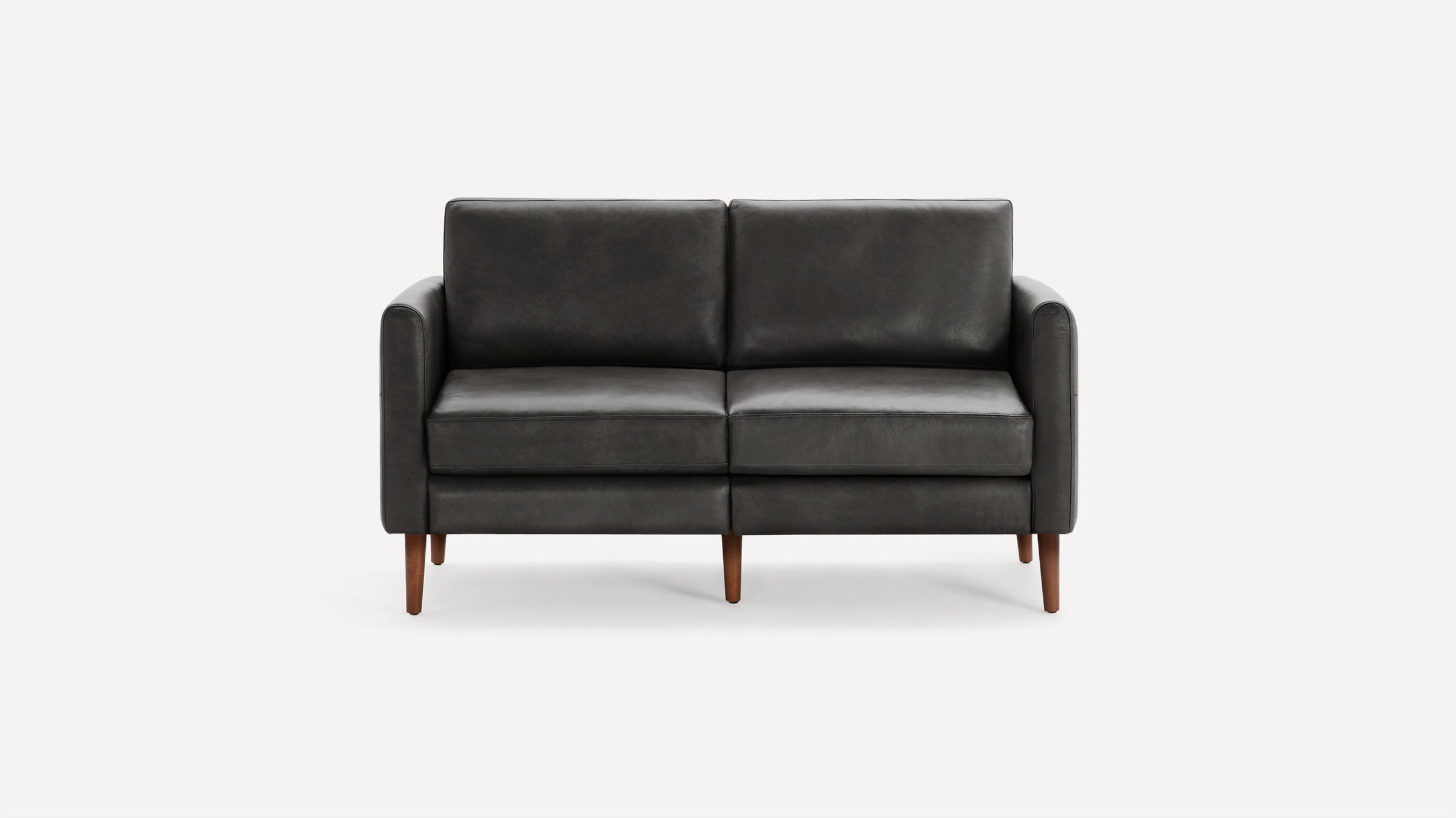 A modern dark grey leather loveseat sofa with wooden legs and clean, minimalist design, shown against a plain white background.