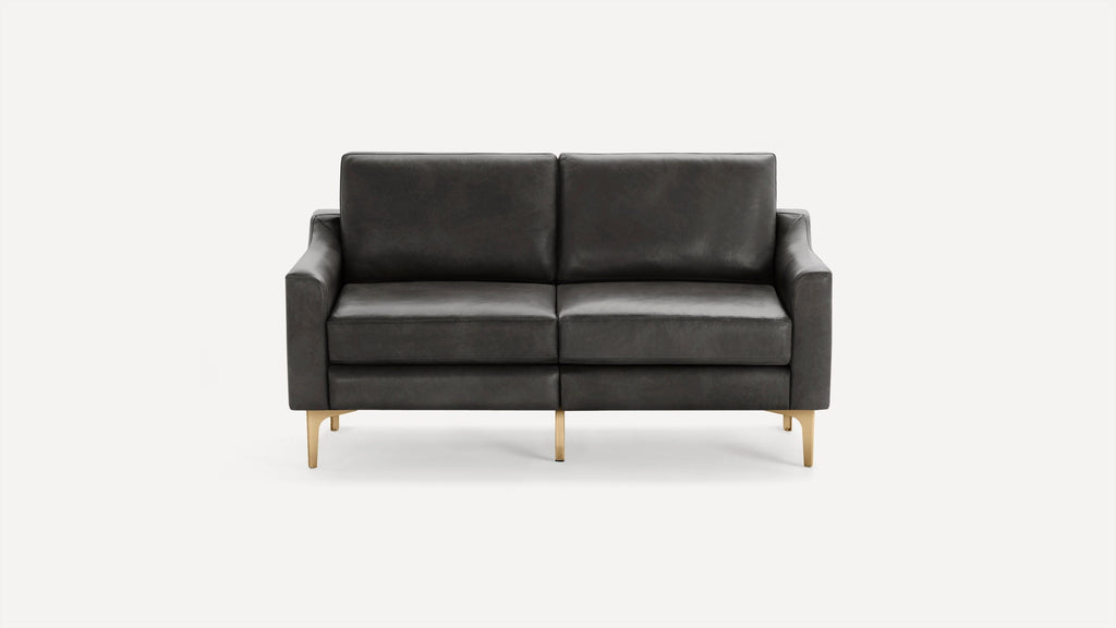 Modern dark gray leather two-seater sofa with slim armrests and gold metal legs, set against a plain white background.