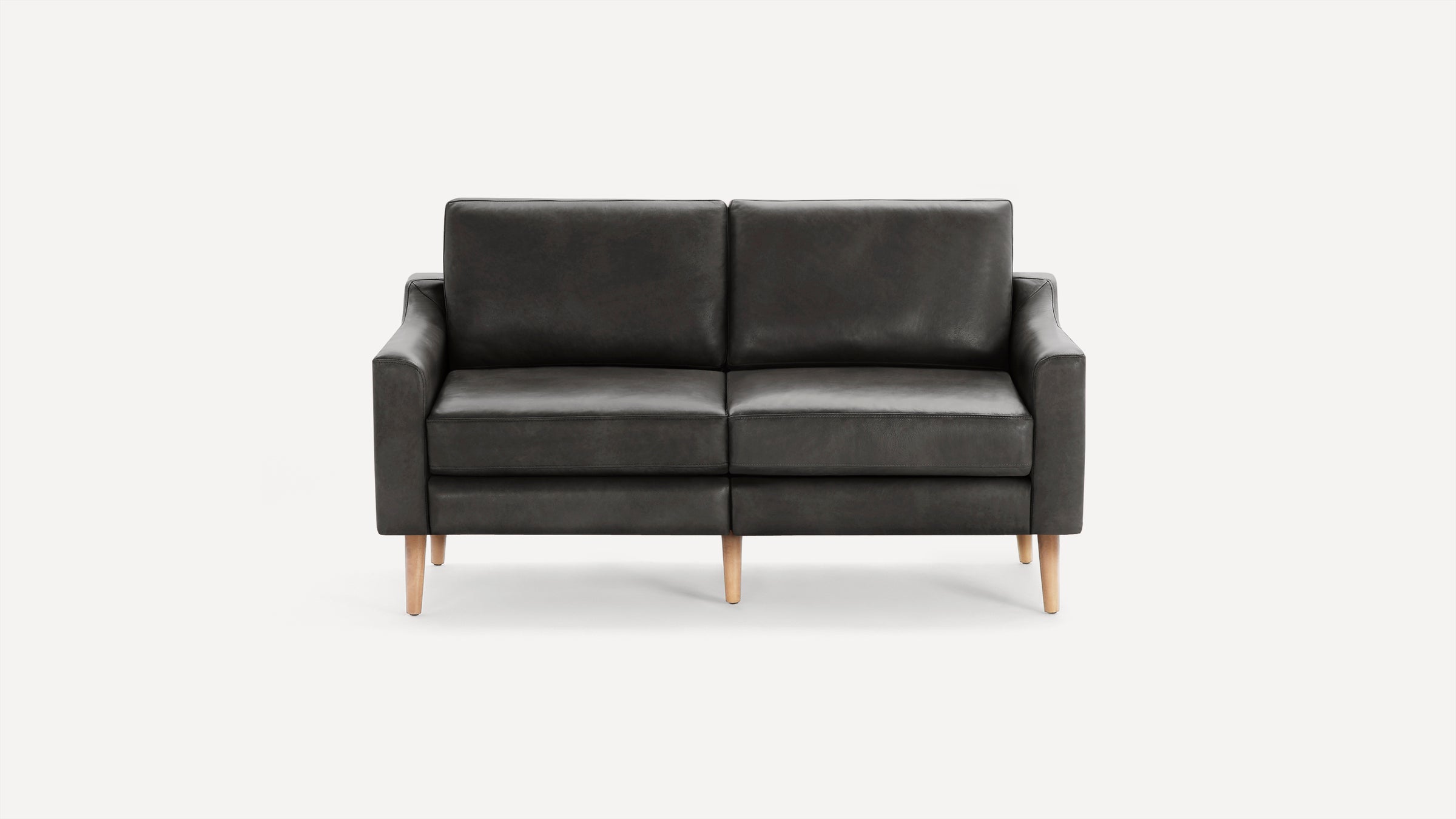 Modern black leather two-seater sofa with clean lines, square arms, and natural wooden tapered legs on white background.