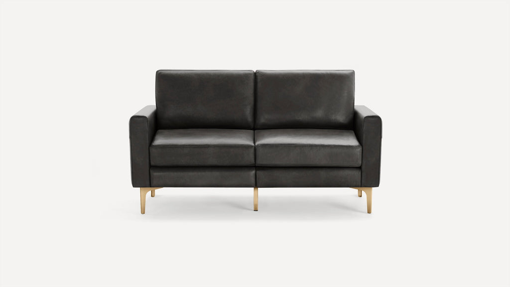 Modern two-seater sofa with dark gray leather upholstery and gold metal legs, featuring clean lines and cushioned armrests.