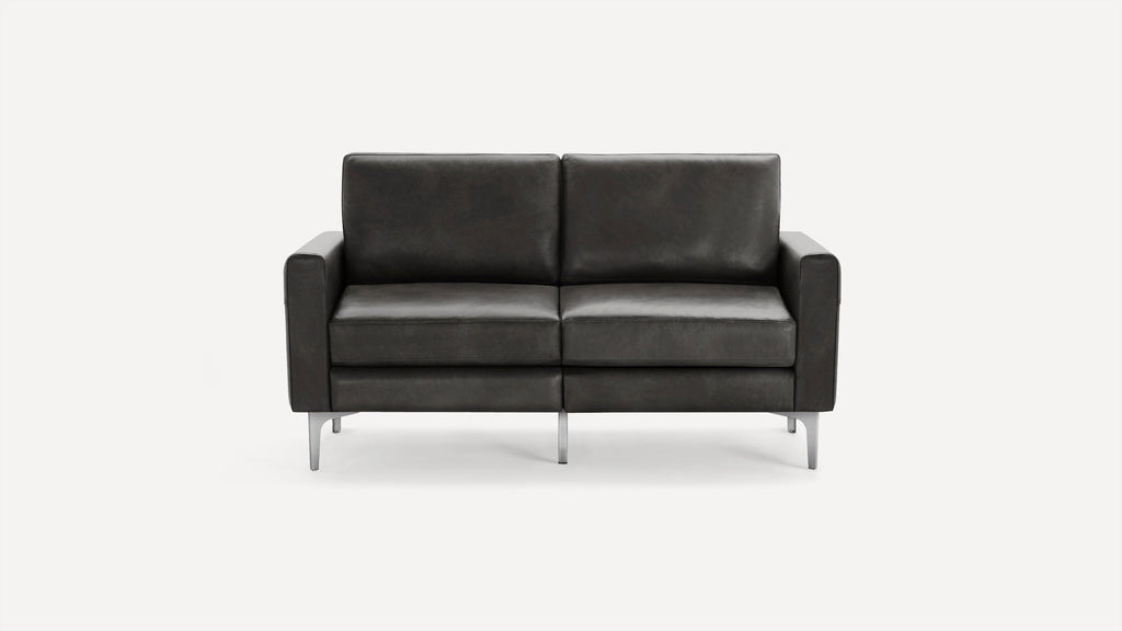 Modern dark gray leather loveseat sofa with square armrests and slim metal legs on a plain white background.