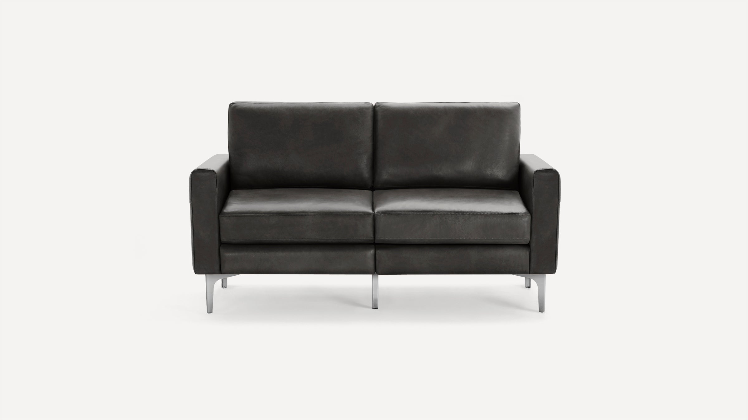 Modern dark gray leather loveseat sofa with square armrests and slim metal legs on a plain white background.