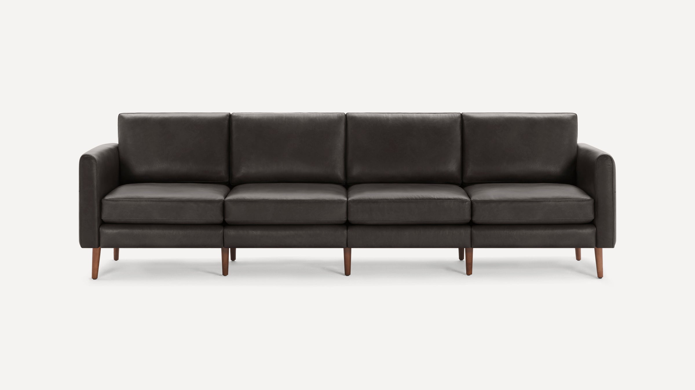 Dark gray modern four-seater sofa with clean lines, cushioned seats, padded armrests, and wooden tapered legs on white background.